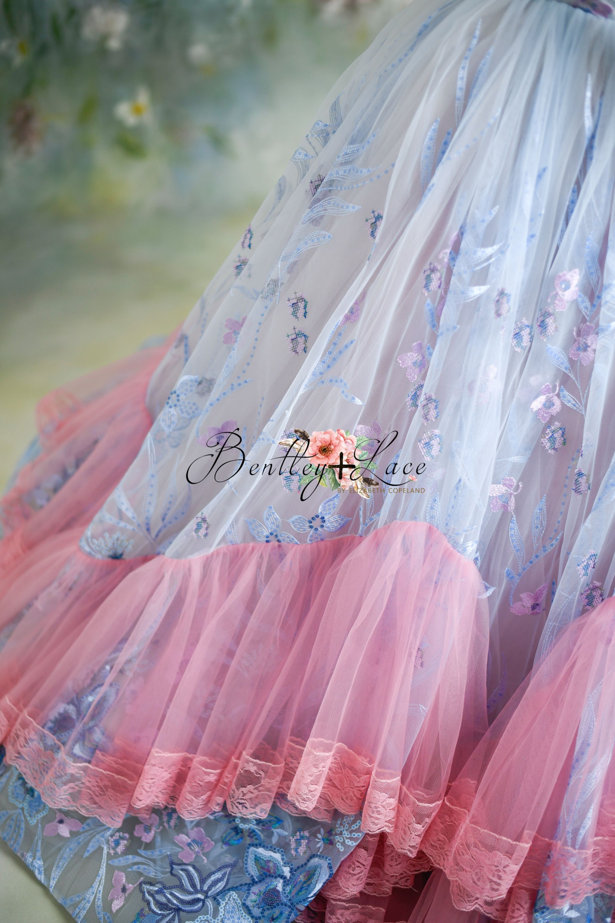 "Elegant Savannah Bloom gown in soft pink, showcasing its stunning lace and sequin details, perfect for a photoshoot."