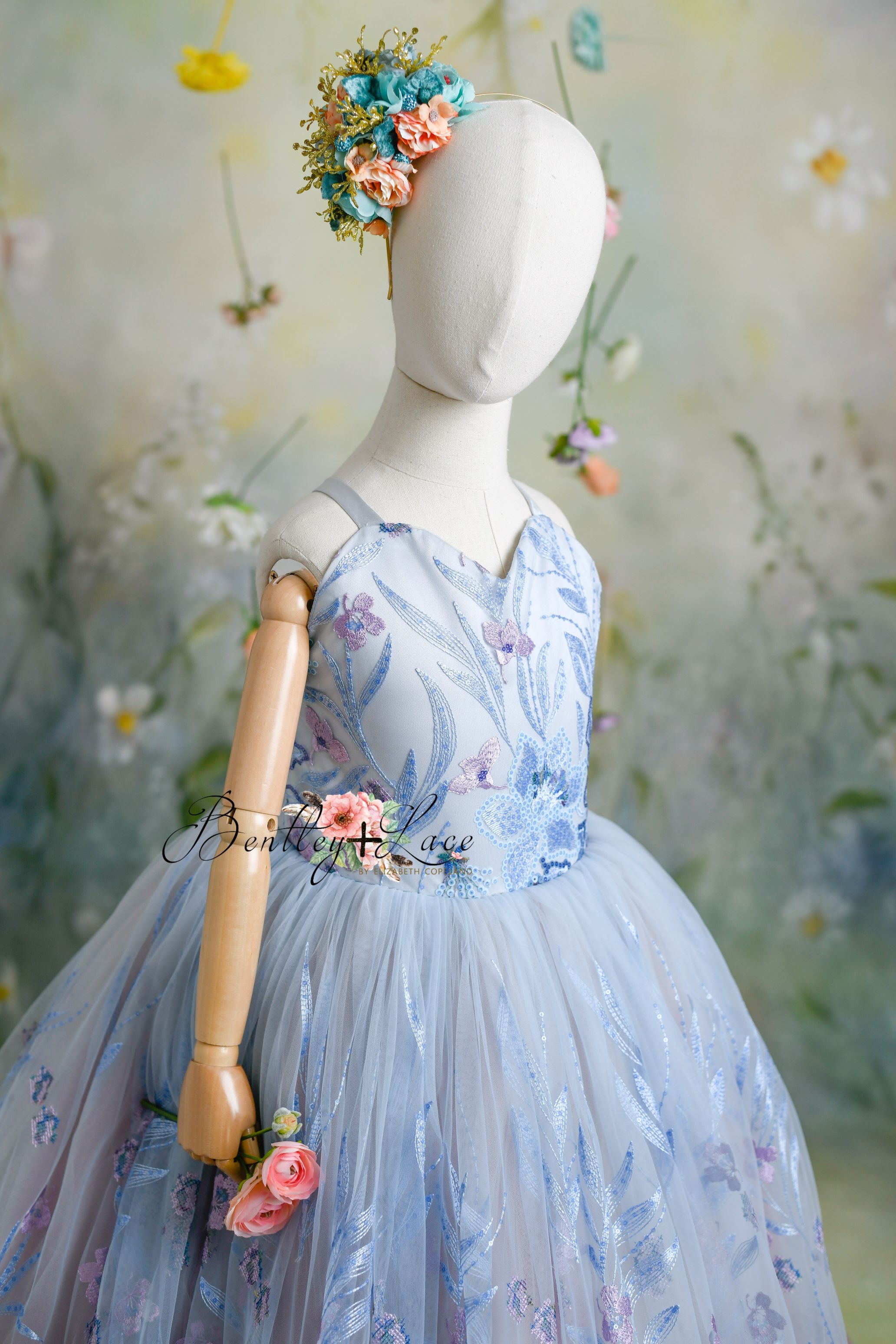 "Back view of the Savannah Bloom gown showing adjustable shoulder ties and elastic back for a flexible fit."