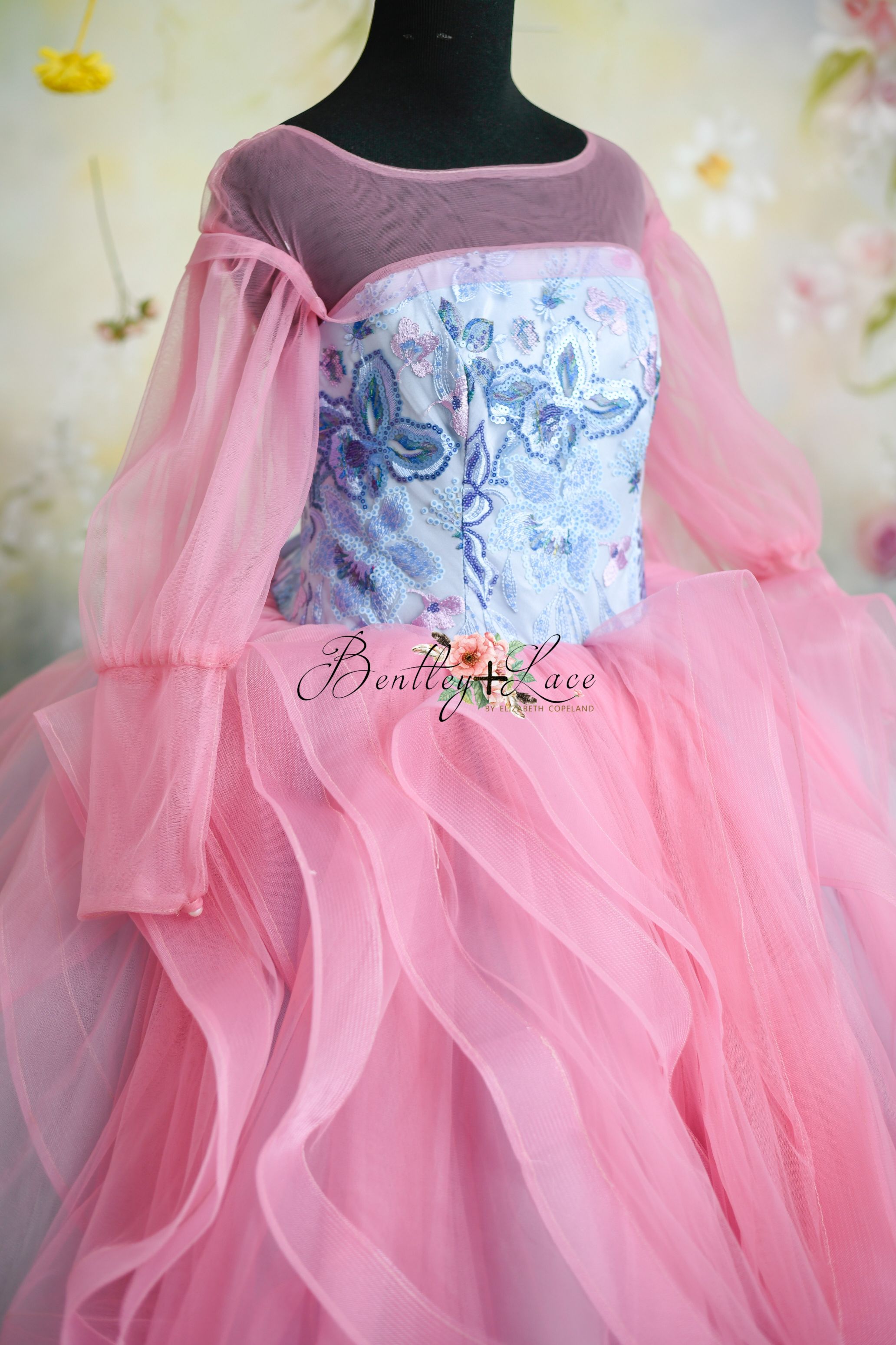 Pink and blue couture ballgown with floral embroidery and sheer detailing.