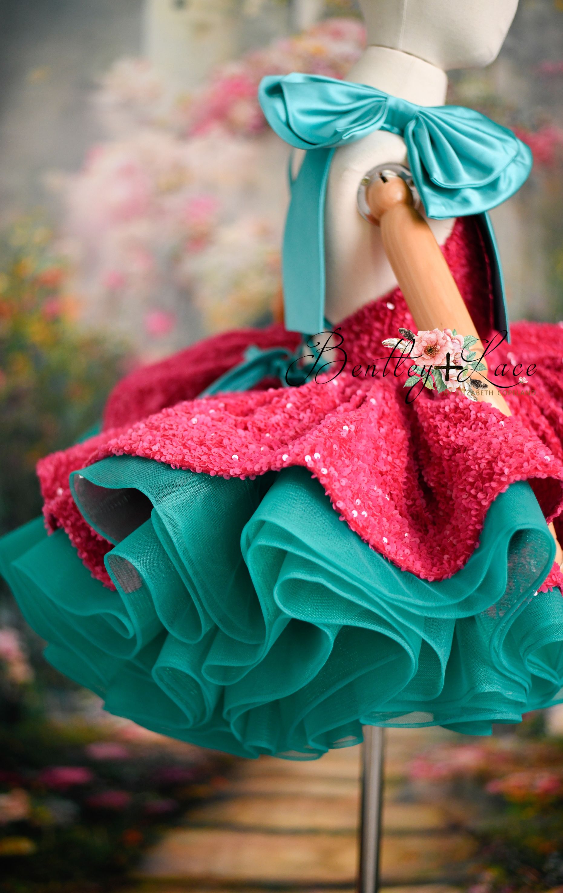 Girl twirling in pink sequin dress with colorful turquoise tulle during photo shoot