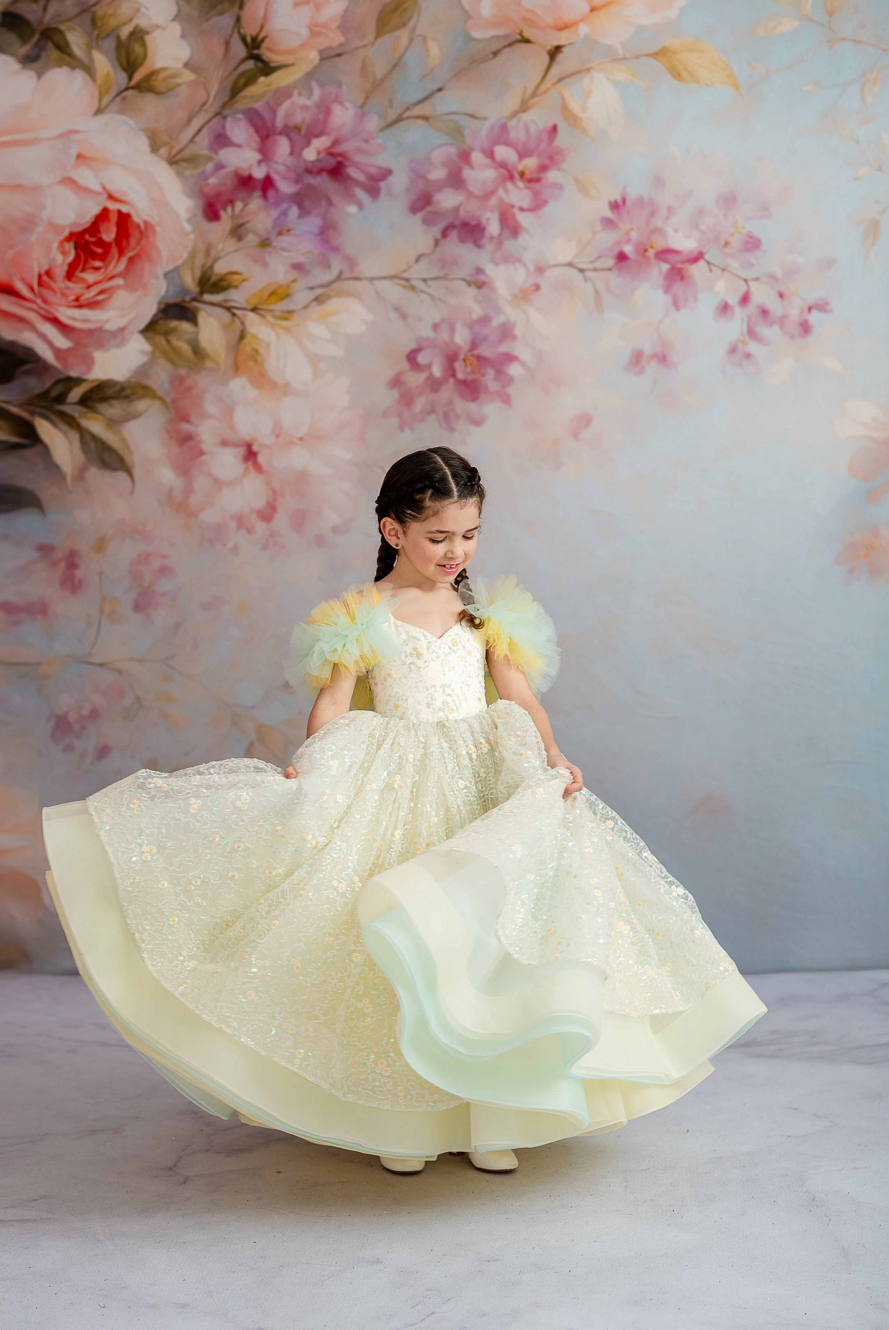 The Harmony Gown sparkles with delicate floral embroidery, pleated tulle accents, and a full skirt designed for magical moments.