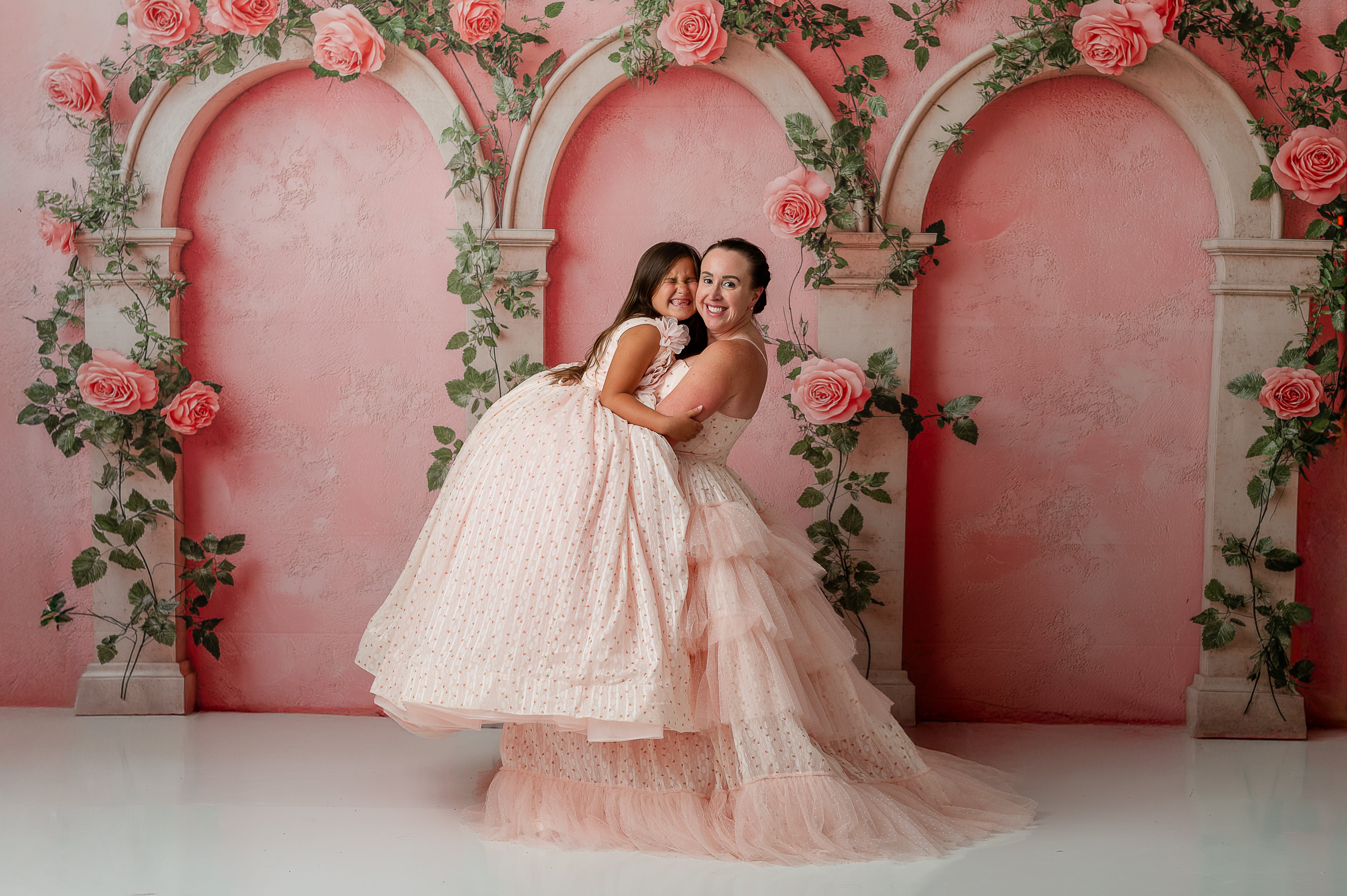 Mommy and Me photo shoot with Sugar Rosette gowns twirling side by side