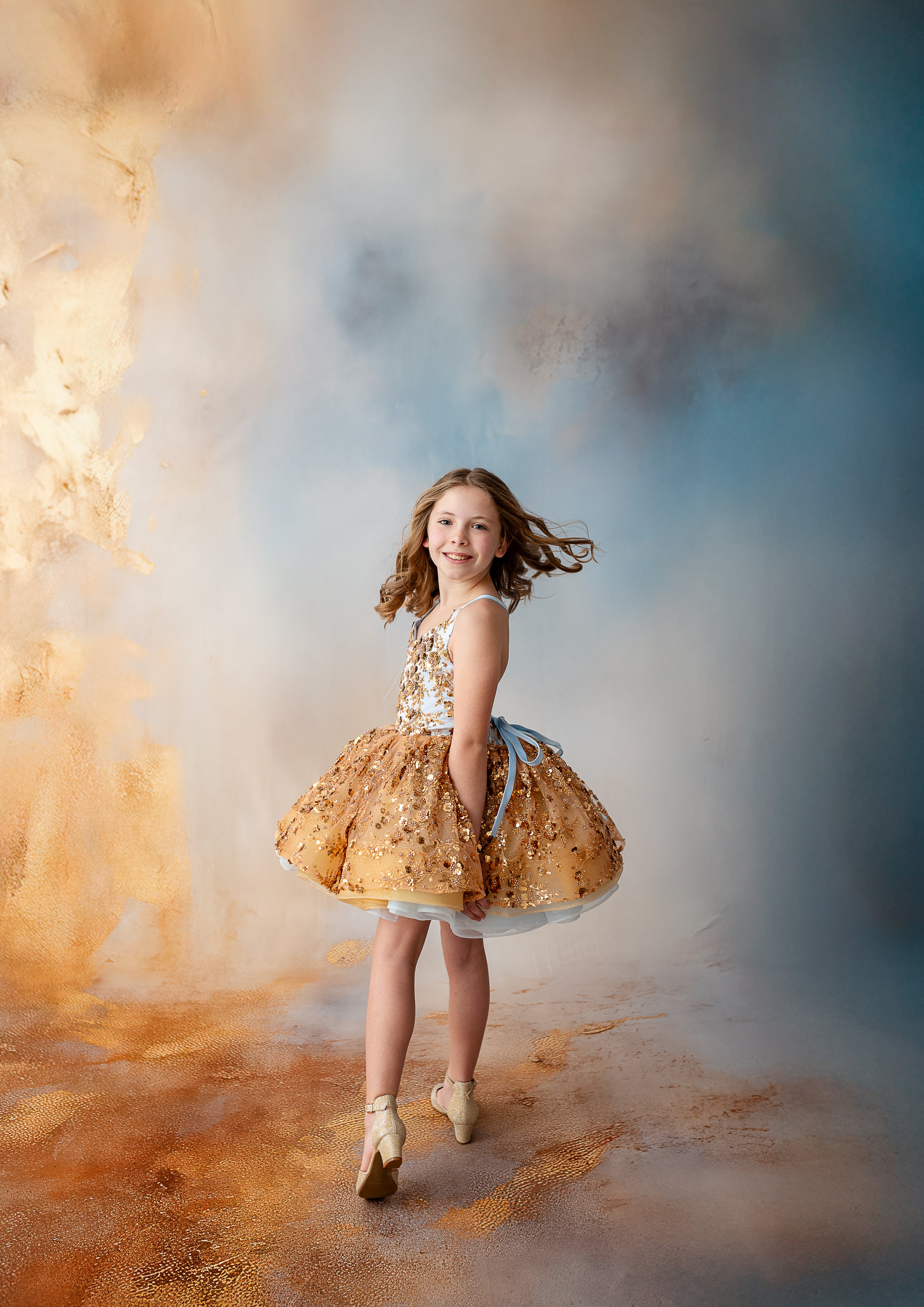 "Step into a fairytale with Cinderella’s Glow, a gown adorned with golden sequins, airy tulle, and an elastic waist for comfort."
