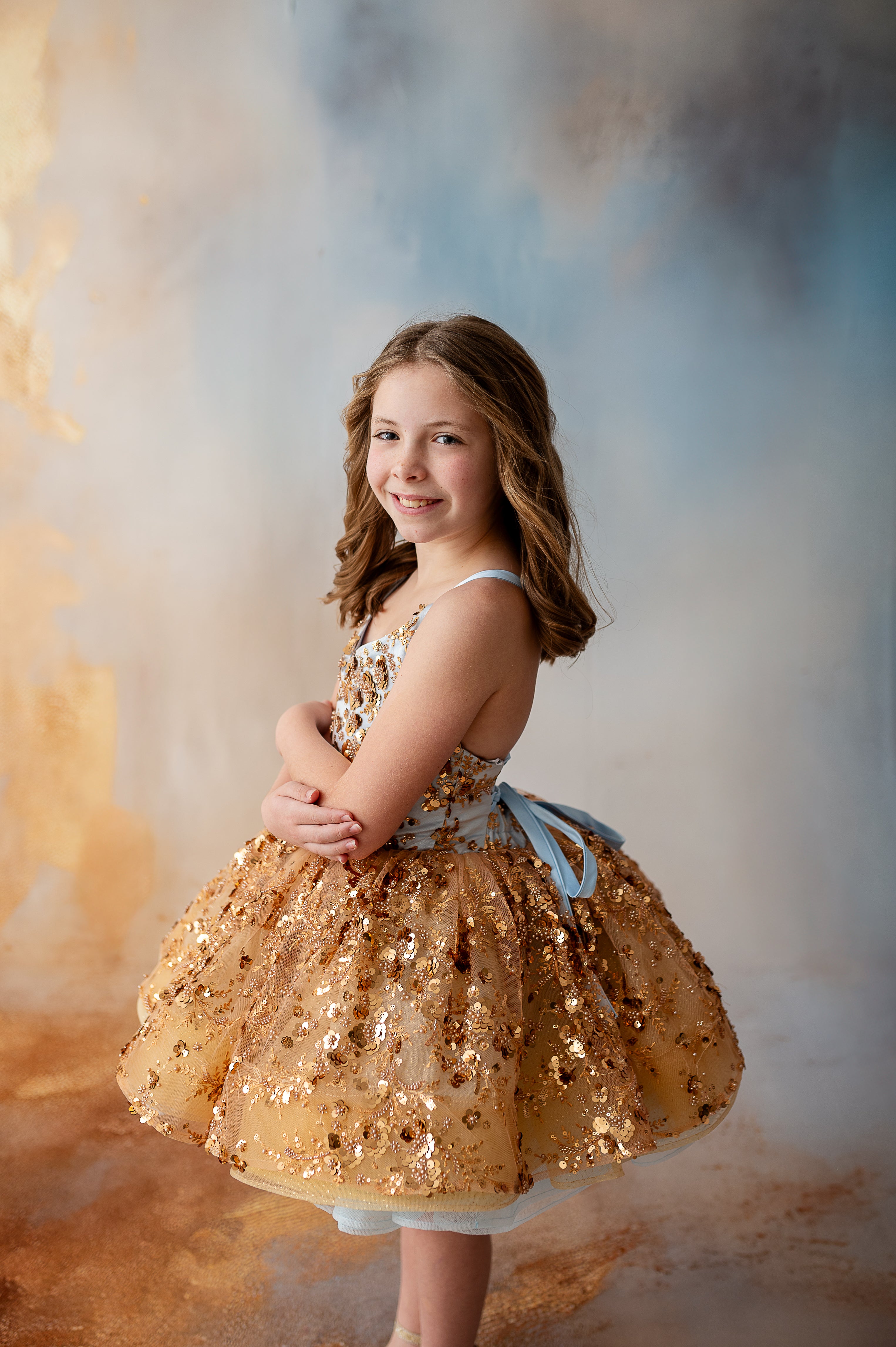 "Cinderella’s Glow gown radiates elegance with its intricate lace, sparkling sequins, and flowing tulle skirt for young princesses."