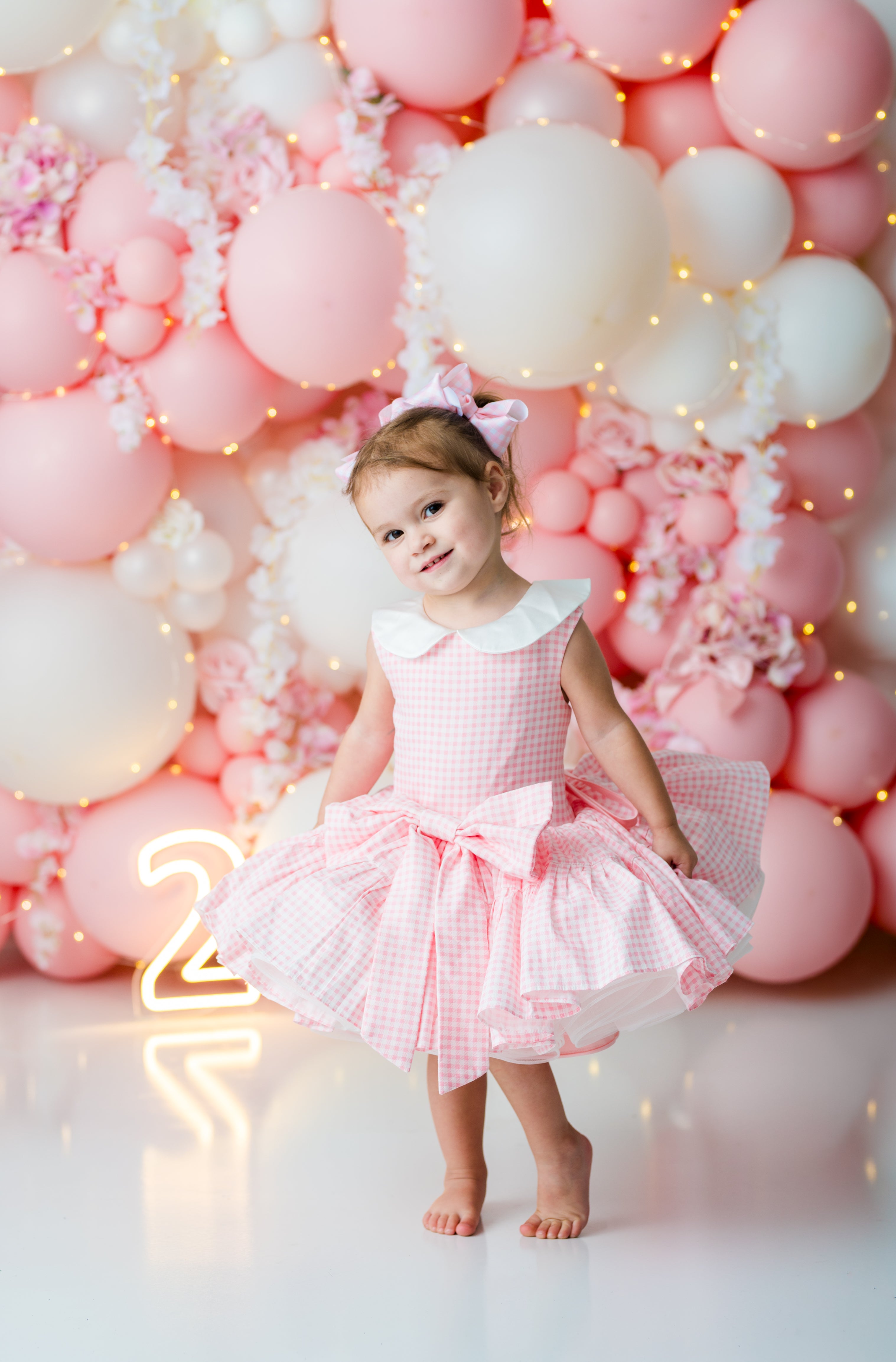 Pink gingham twirl dress with layered bridal tulle and bow