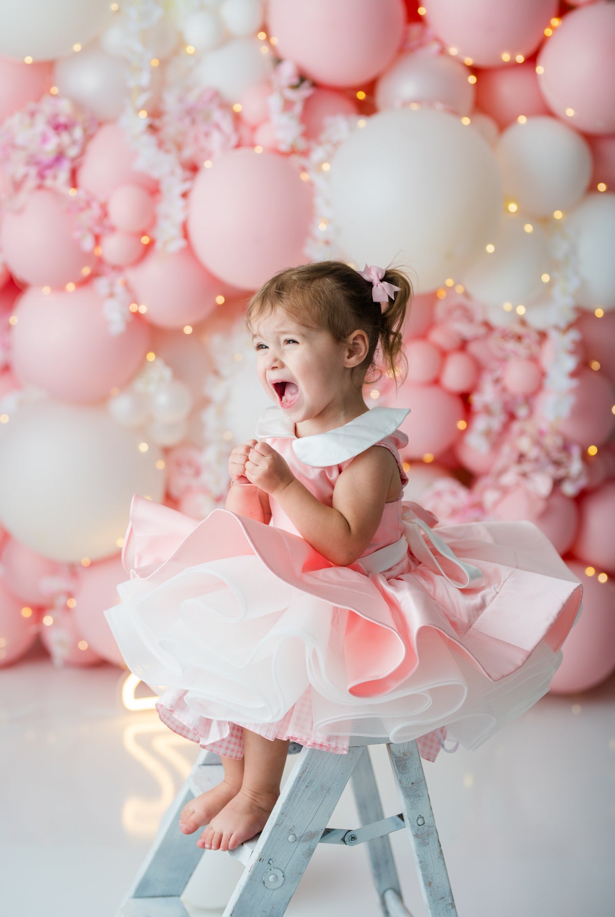 Pink gingham birthday dress with oversized waist bow