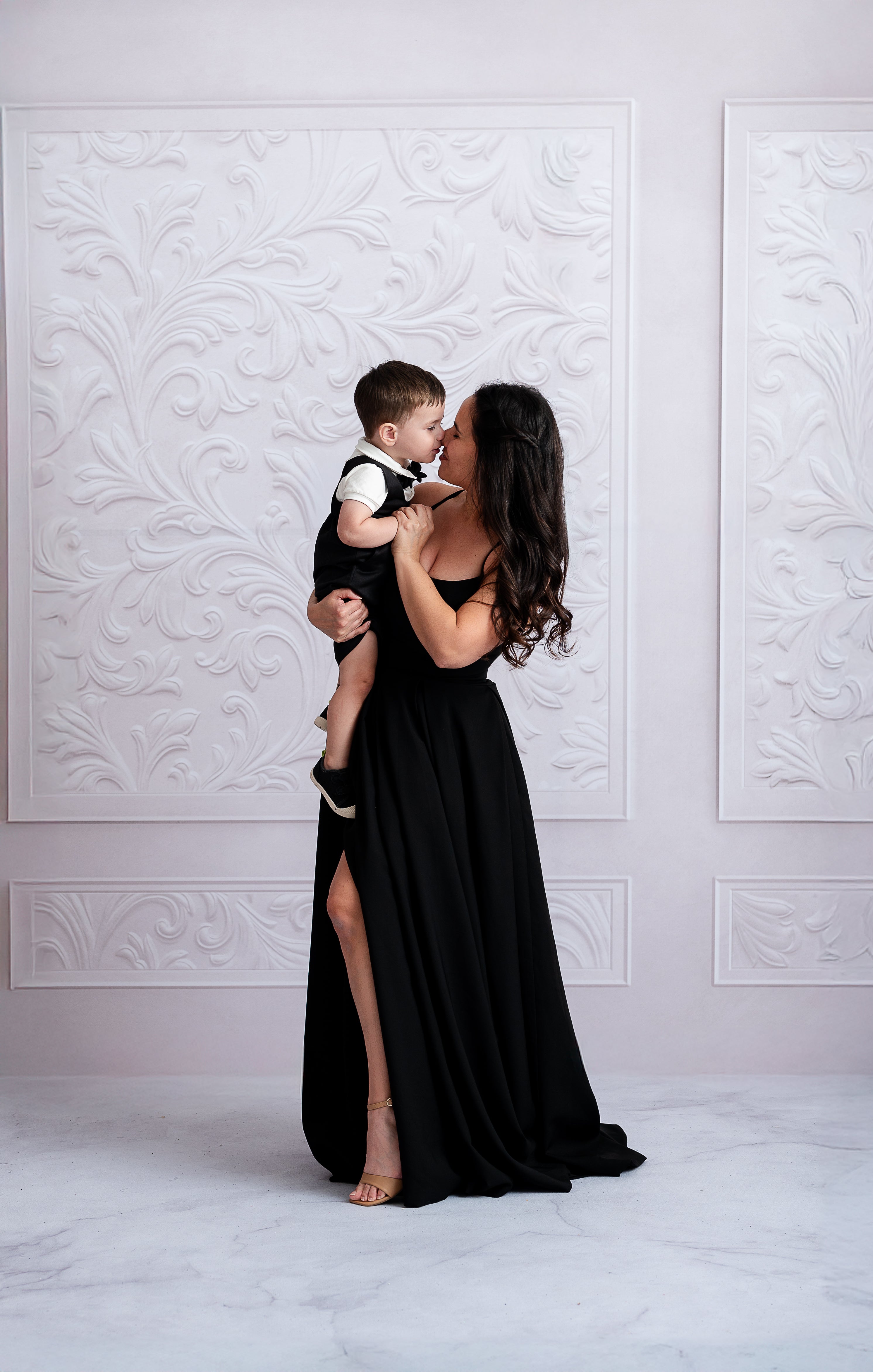 Beautiful mother dressed in a luxurious black custom gown at a special event.