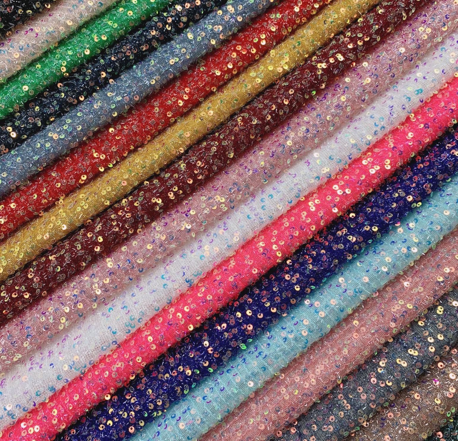 Row of colorful glittery ribbons in various shades.