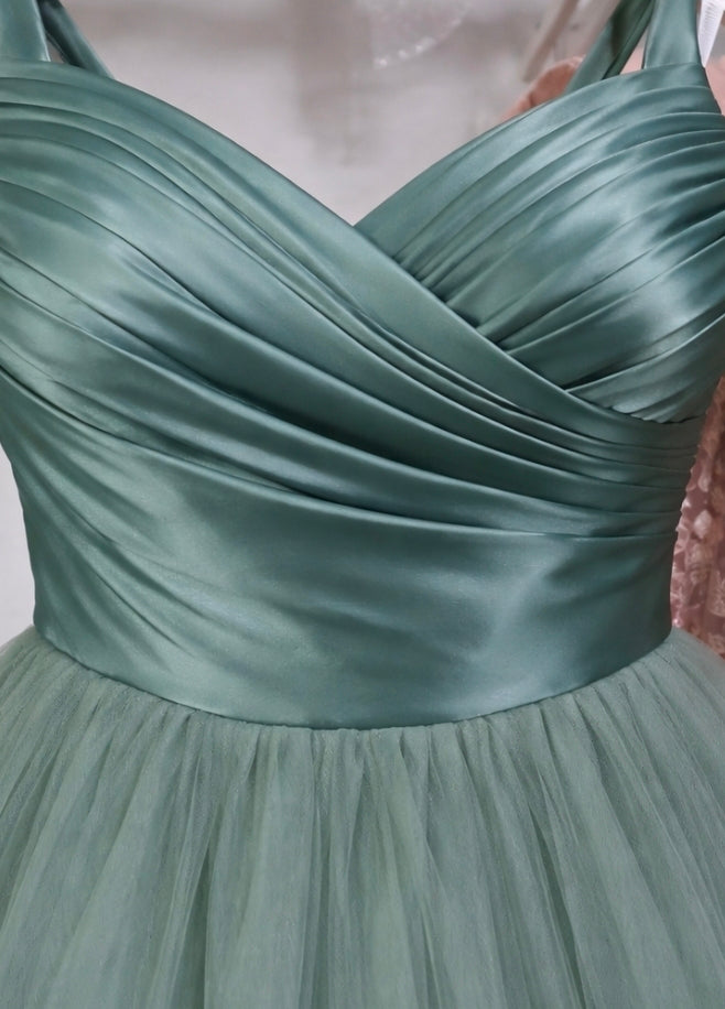 Green satin dress with a V-neckline on a plain background