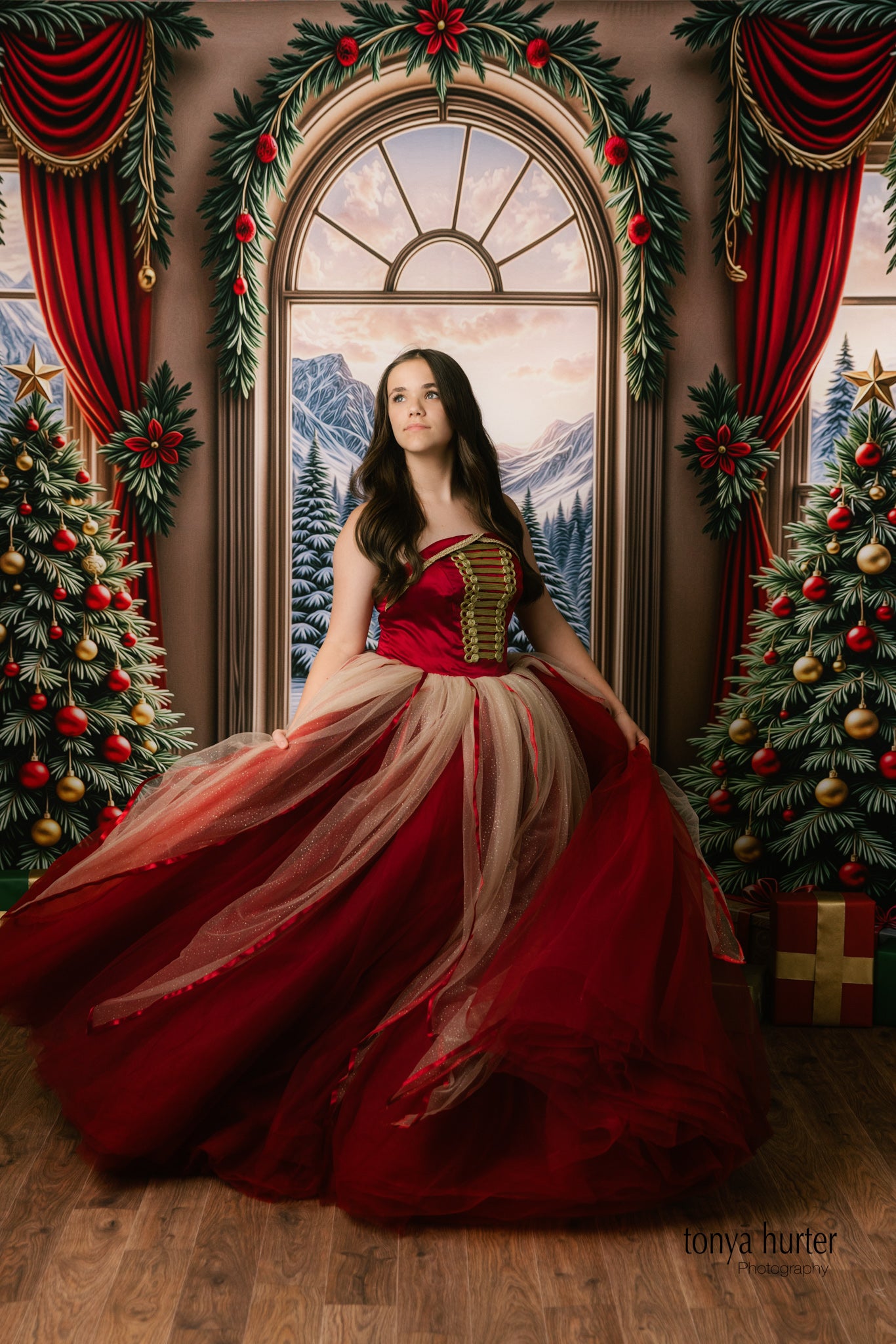 Full-length portrait of child wearing ruby tulle princess dress