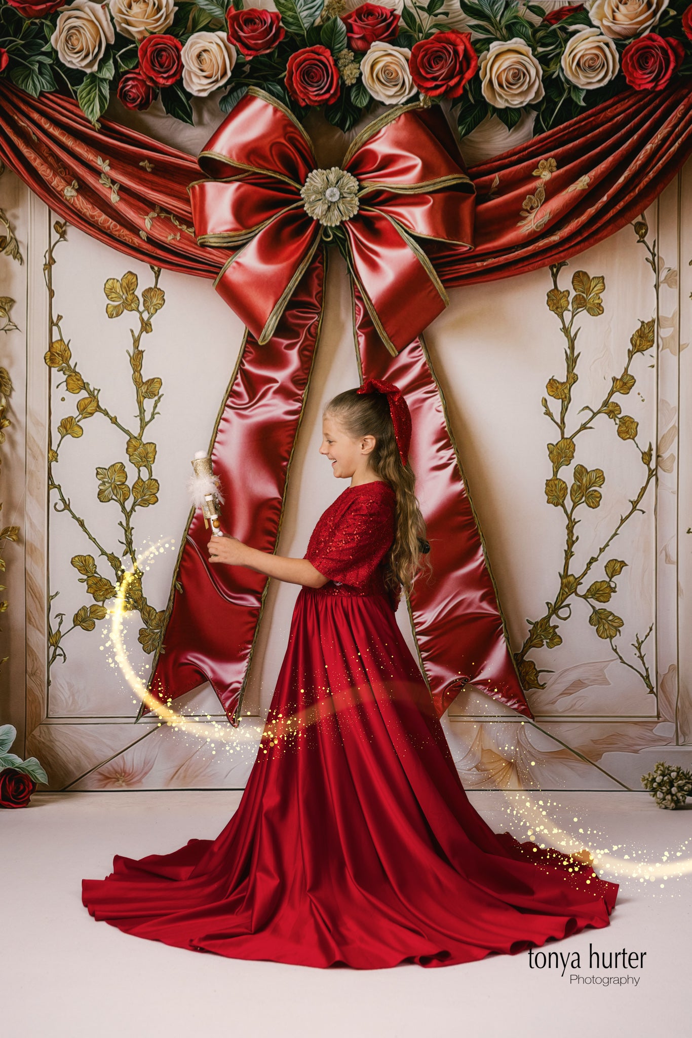 Little fashionista posing in luxurious red silk satin dress