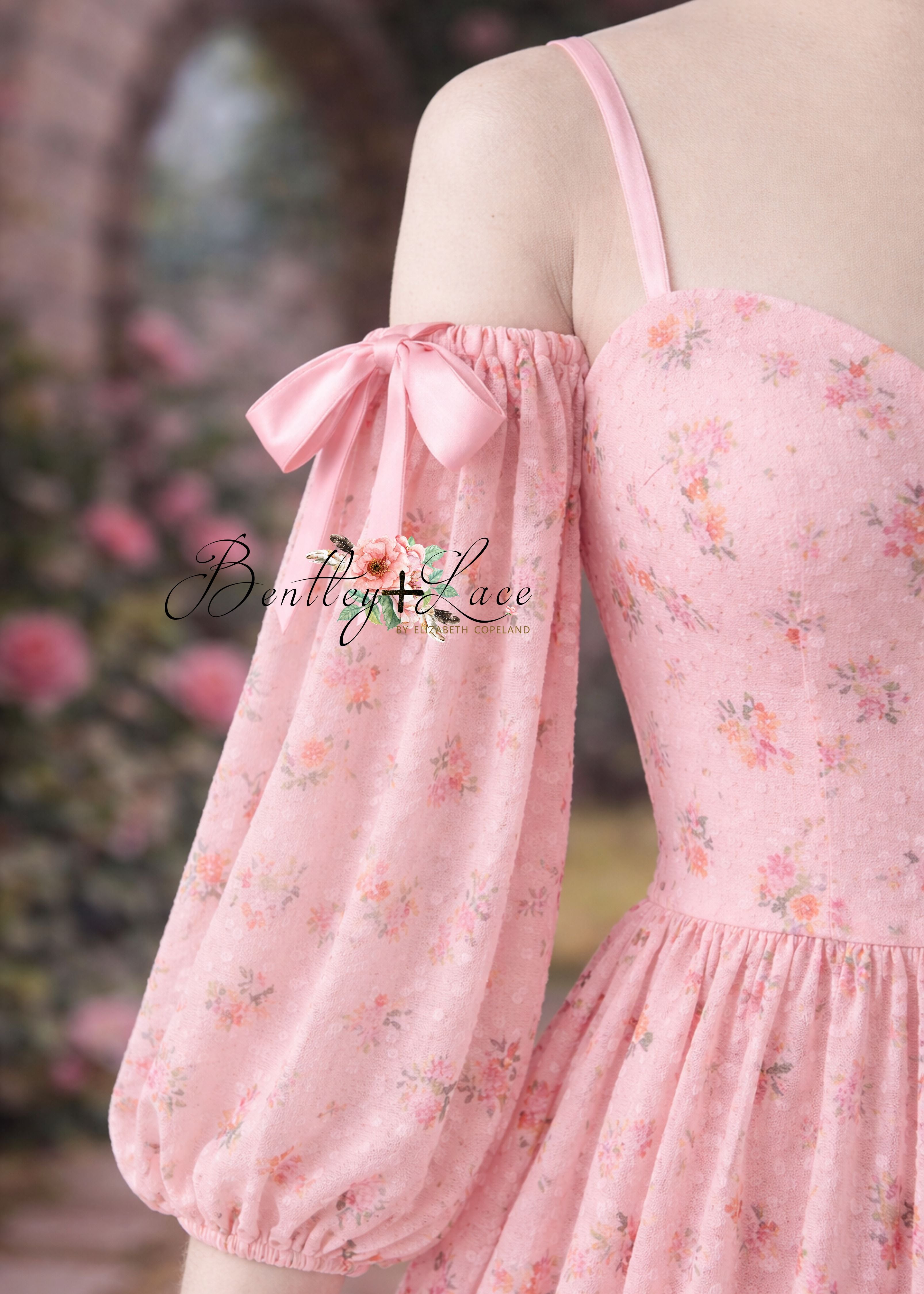 Pink floral dress with bow detail on a blurred background