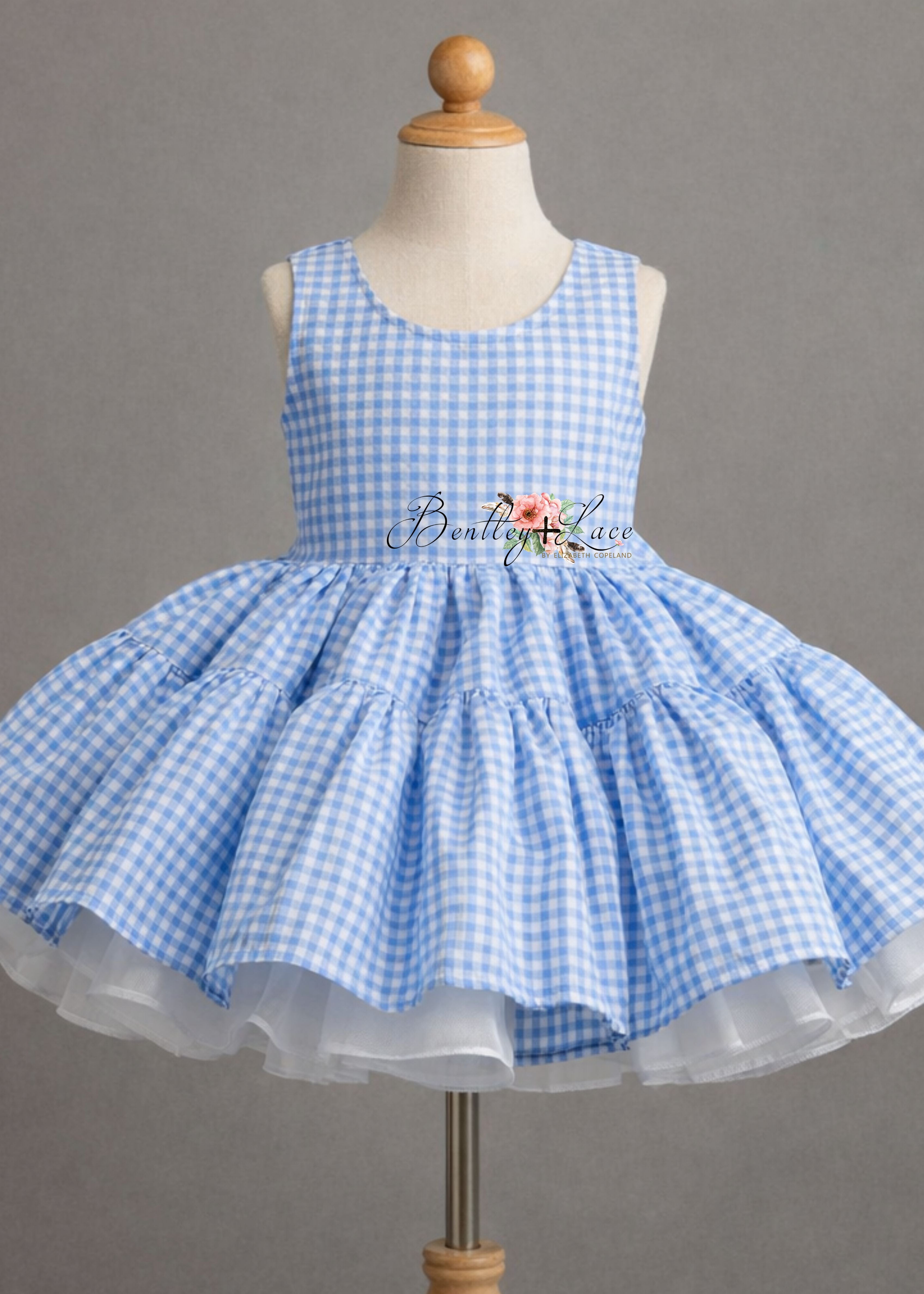 Blue checkered dress on a mannequin against a gray background