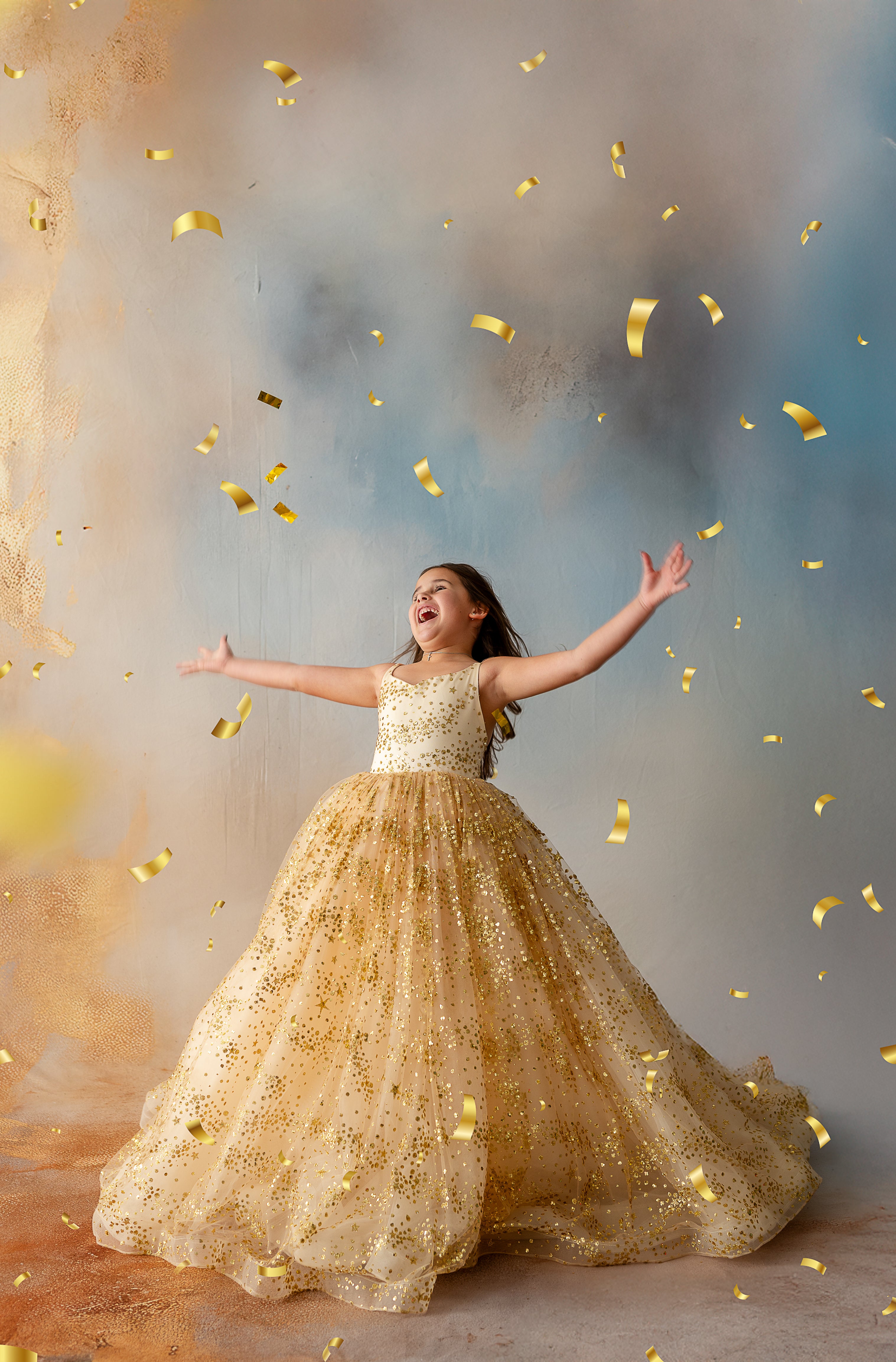 Child posing in floor-length gold star gown under studio lights