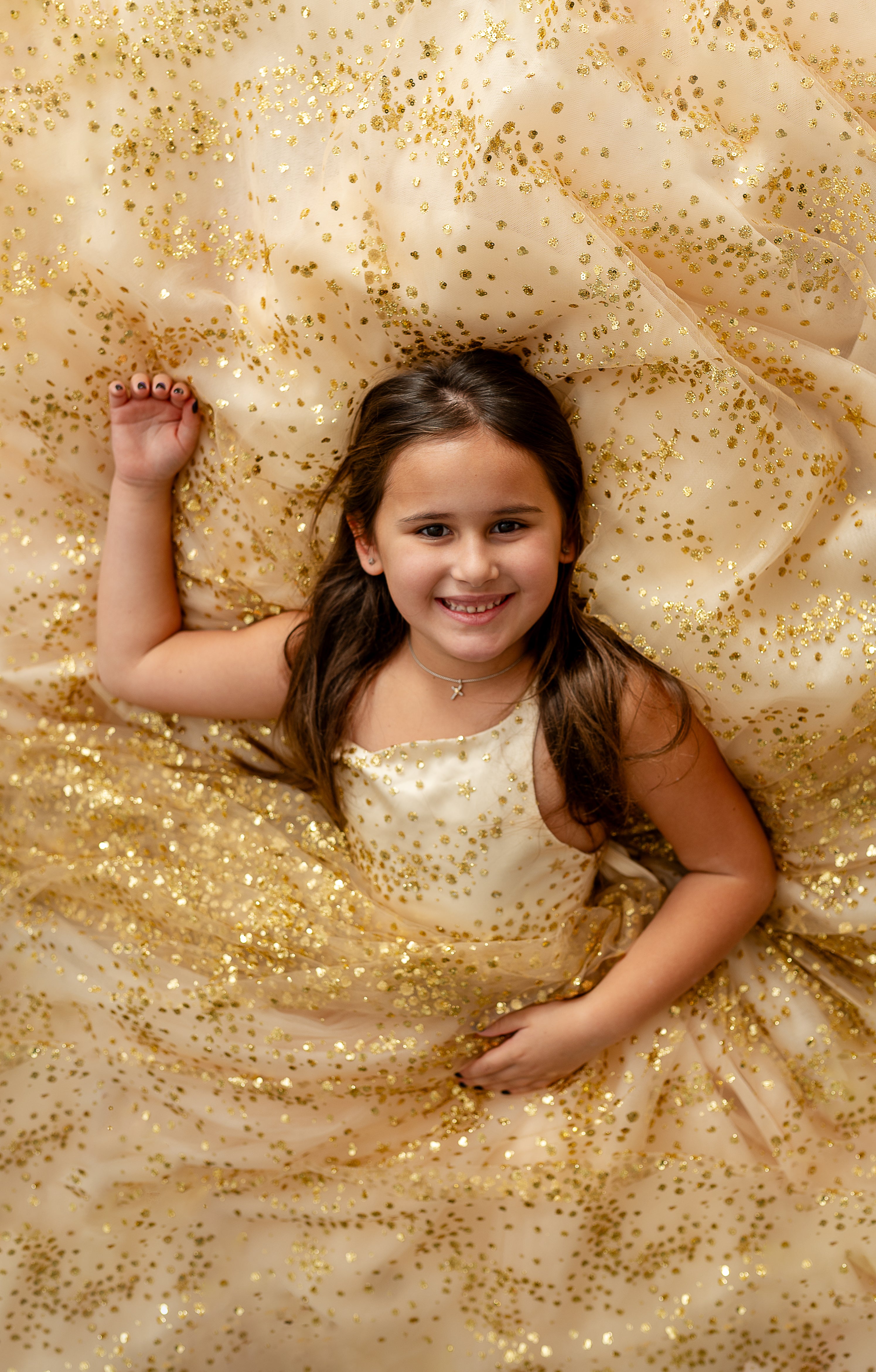 Girl posing with arms out in magical gold star dress