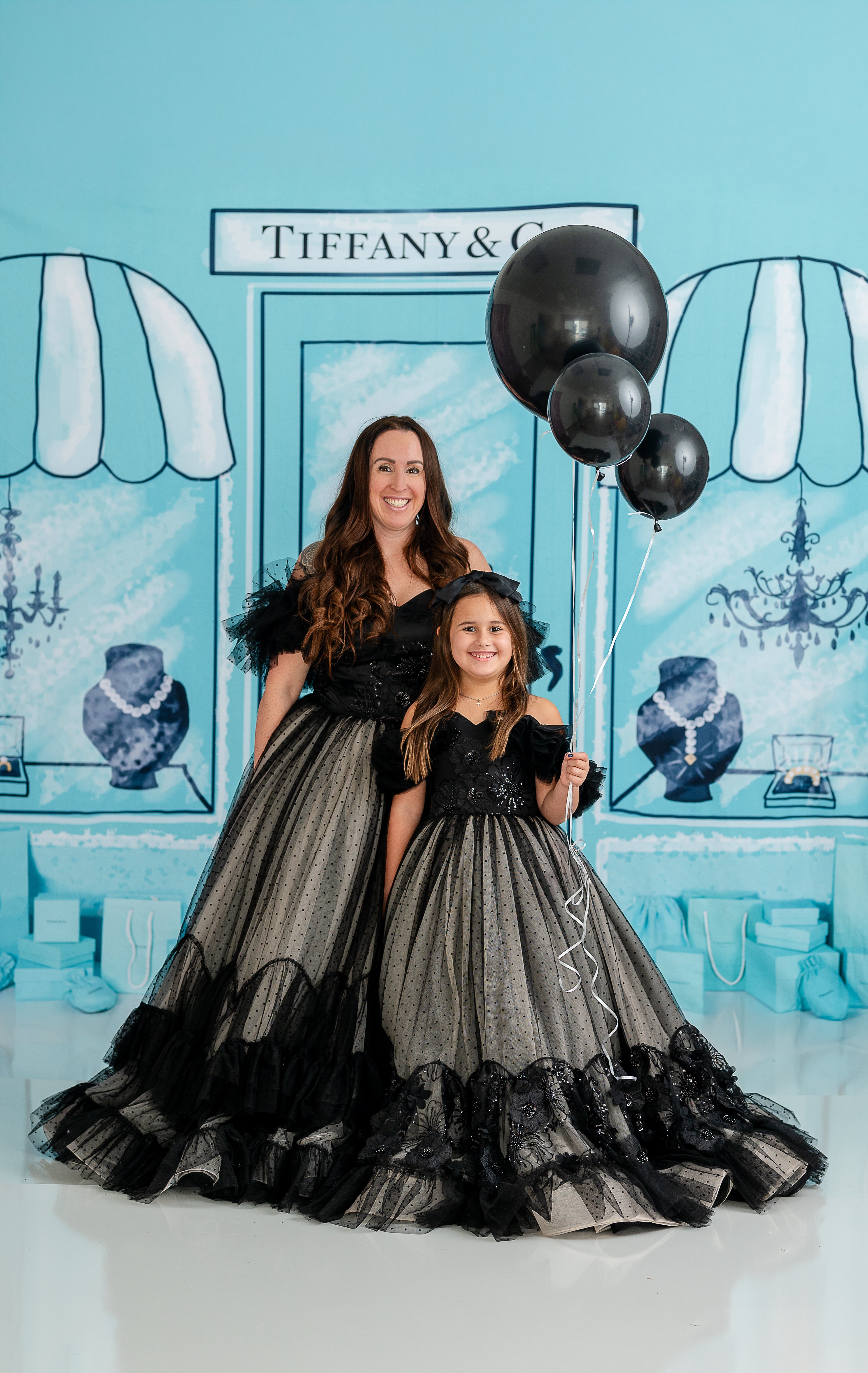 The combination of sheer black tulle and nude lining creates a sophisticated, layered look.