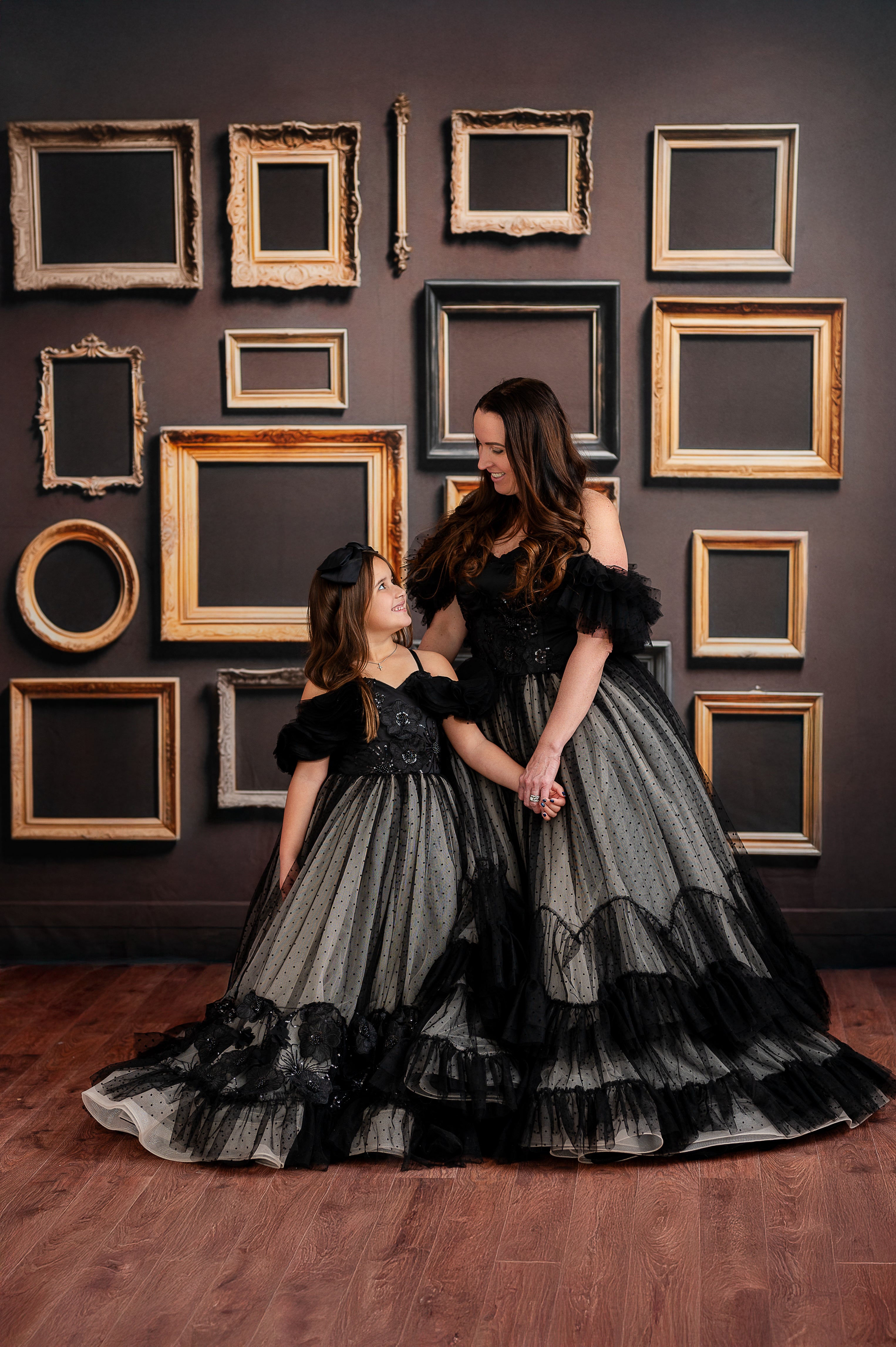 The black tulle overlays give the gown a dramatic yet timeless aesthetic.