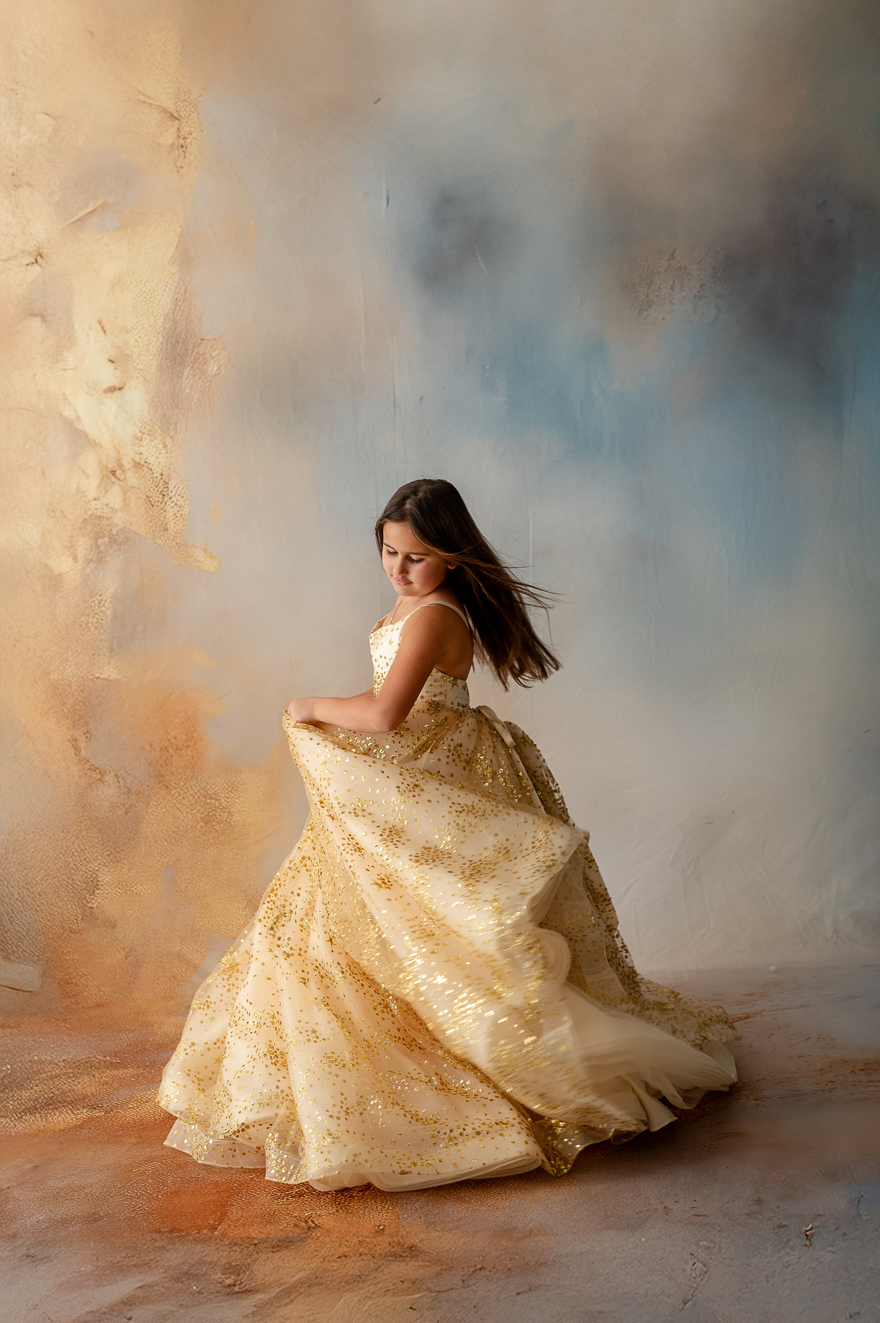 Girl smiling in shimmering gold star tulle dress with puff sleeves