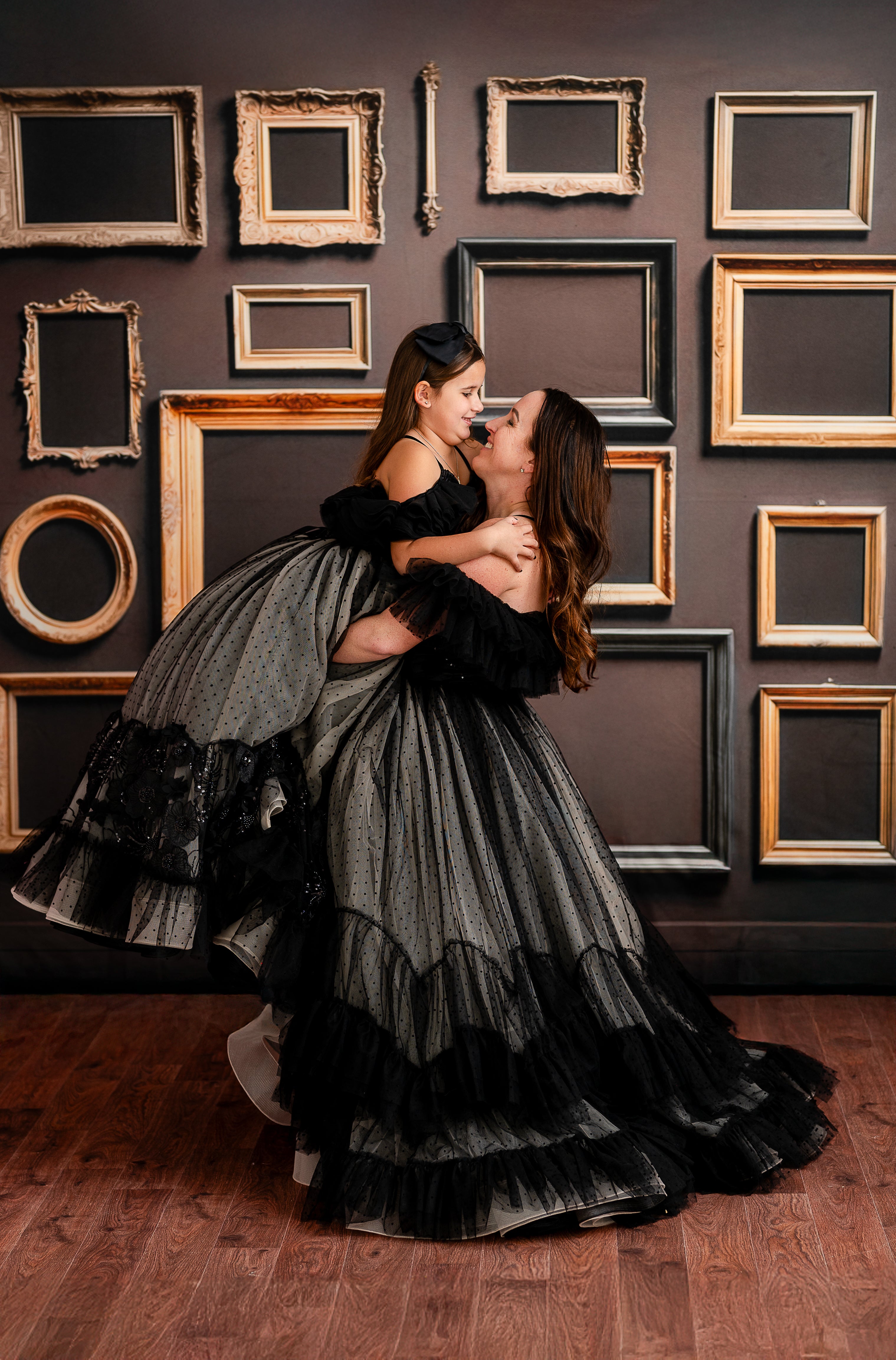 Black and nude polka-dot tulle gown styled with vintage-inspired décor and warm wood flooring.