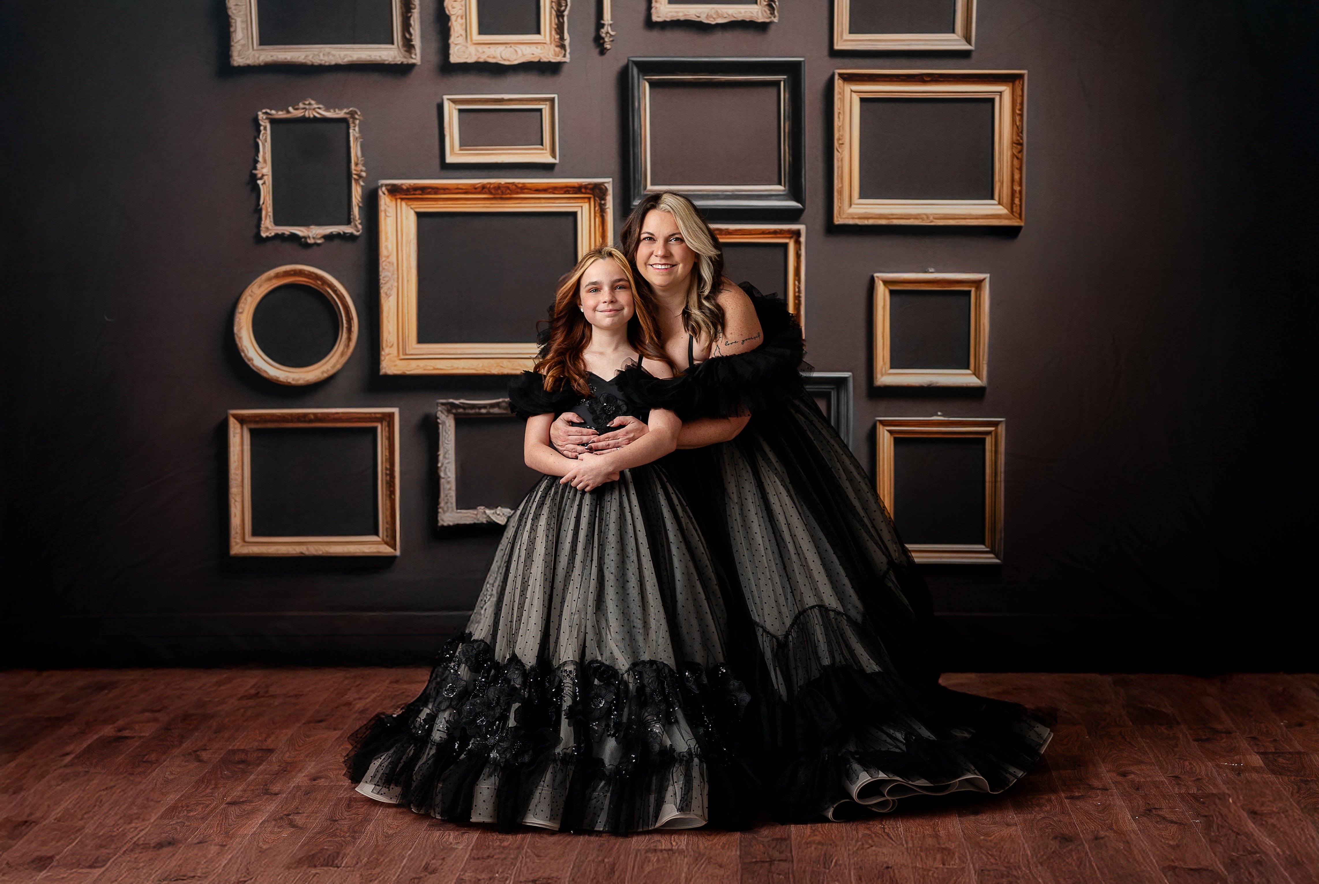 The sheer black tulle overlays create a soft and ethereal effect on the full-length couture gown.