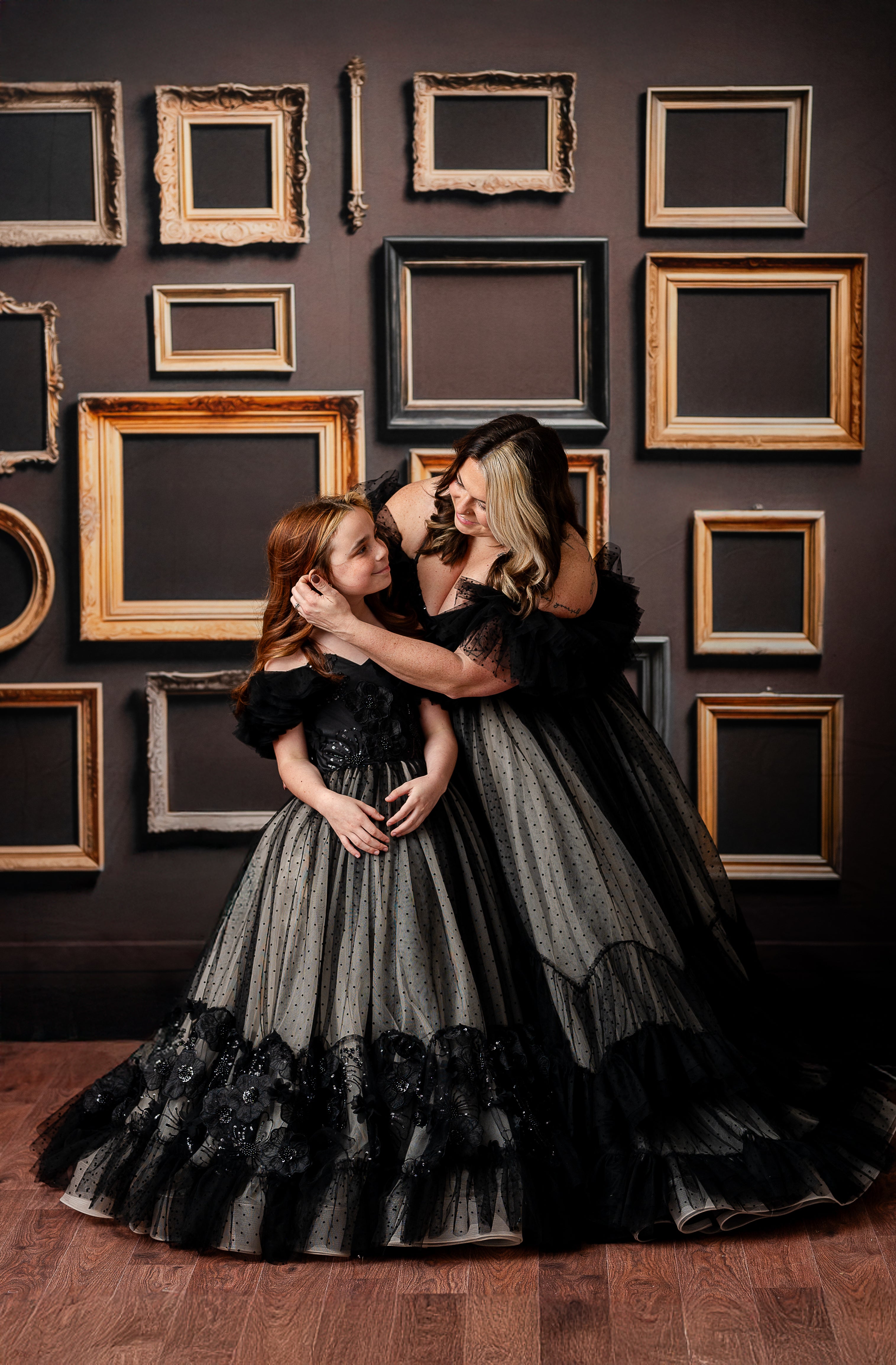 A dramatic black and nude gown with off-the-shoulder ruffled tulle sleeves and lace bodice.