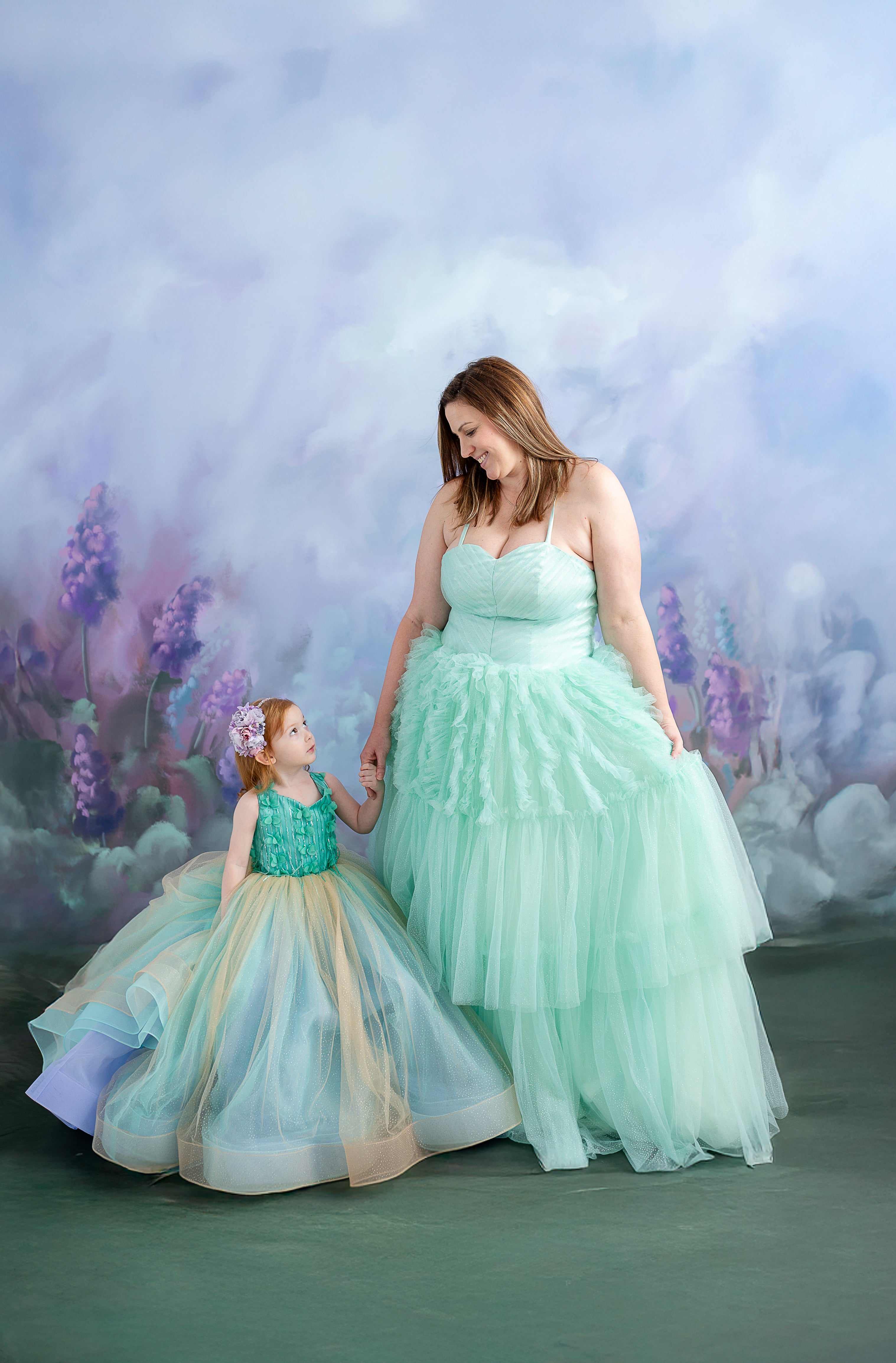 The Evelyn gown displayed on a dress form, highlighting its intricate design and elegant fabric layers.
