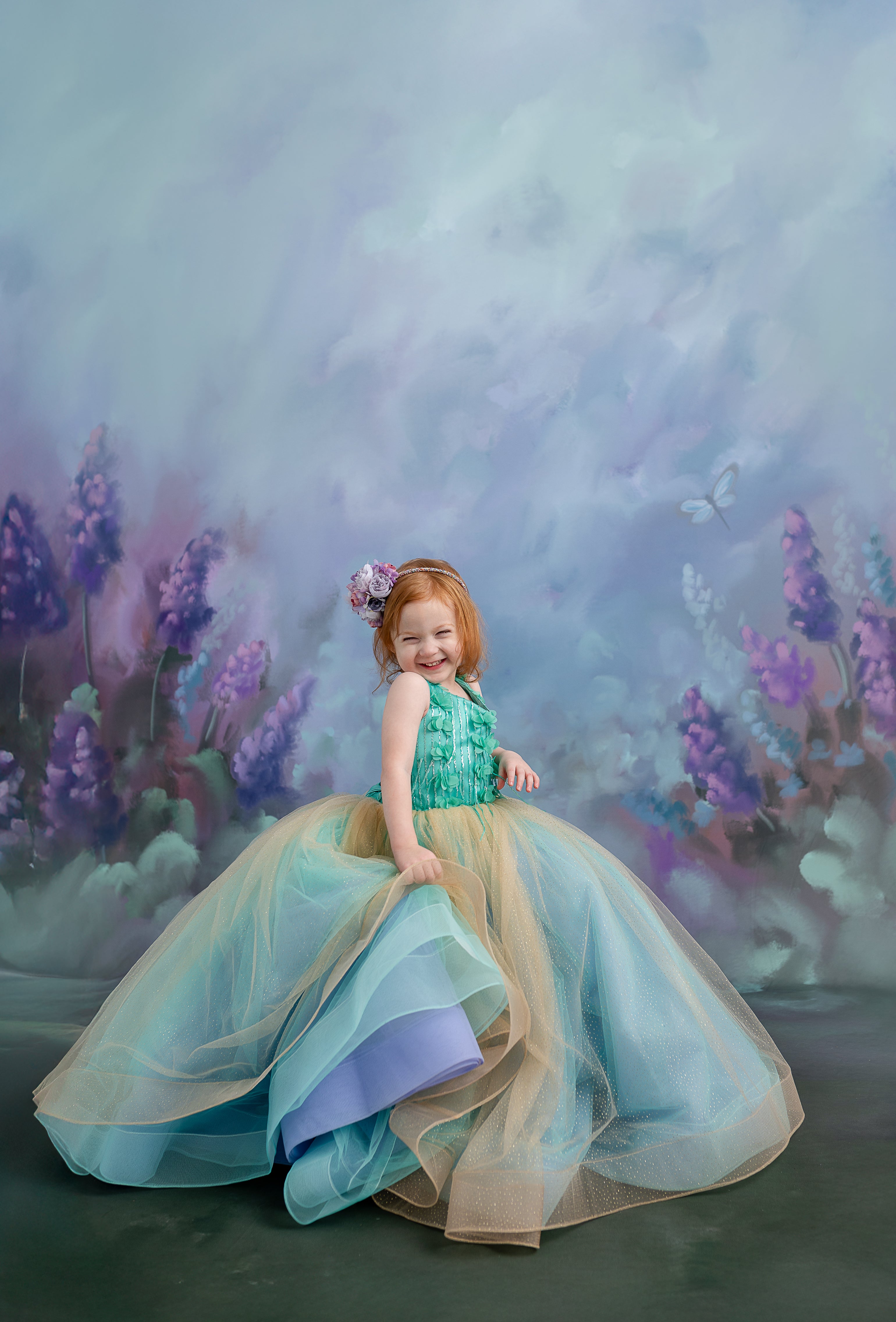 A magical moment captured – a child in the Evelyn gown looking in awe at the flowing fabric around her.