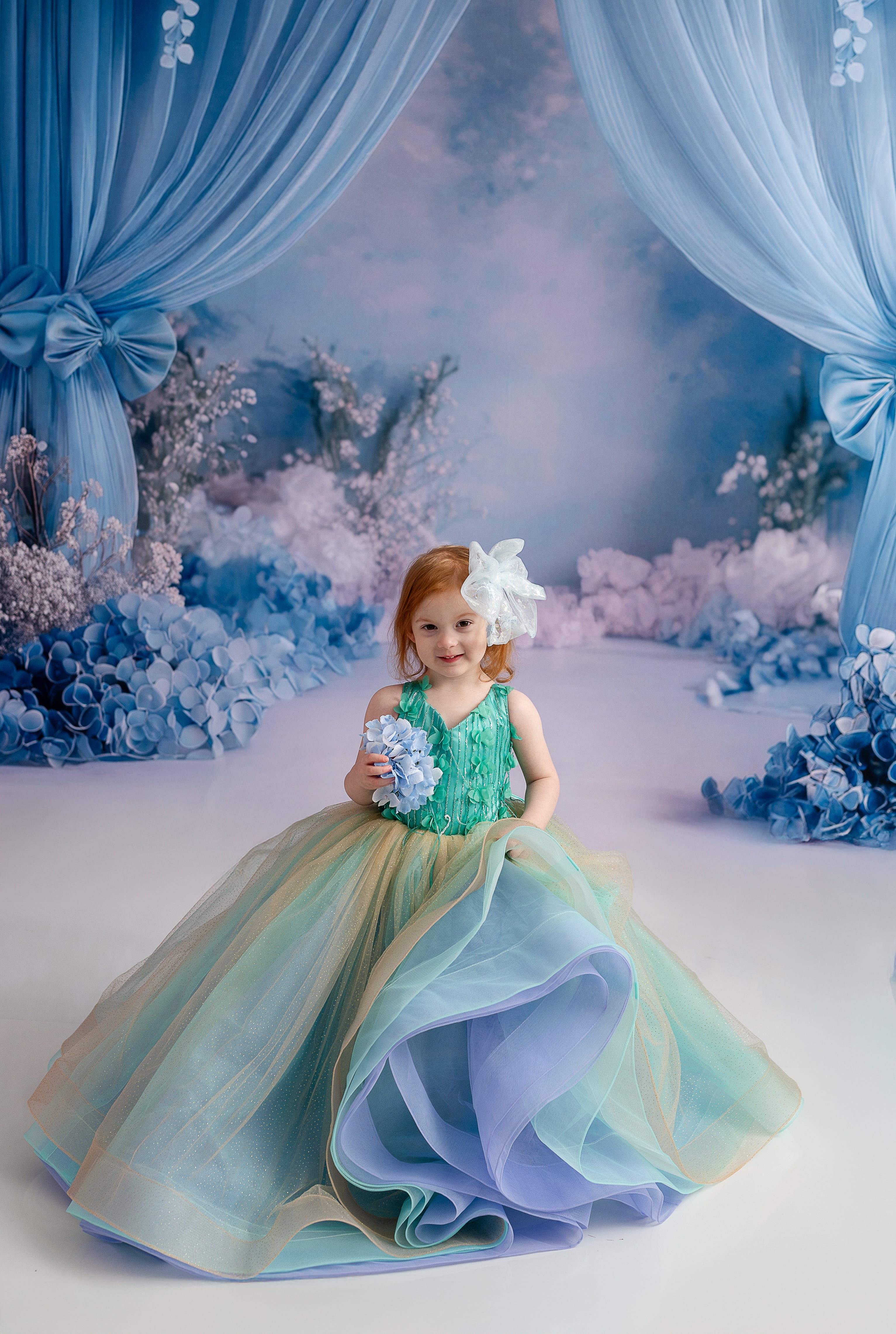 Close-up of the gown’s bodice featuring delicate hand-sewn floral appliqués and textured ruffles.