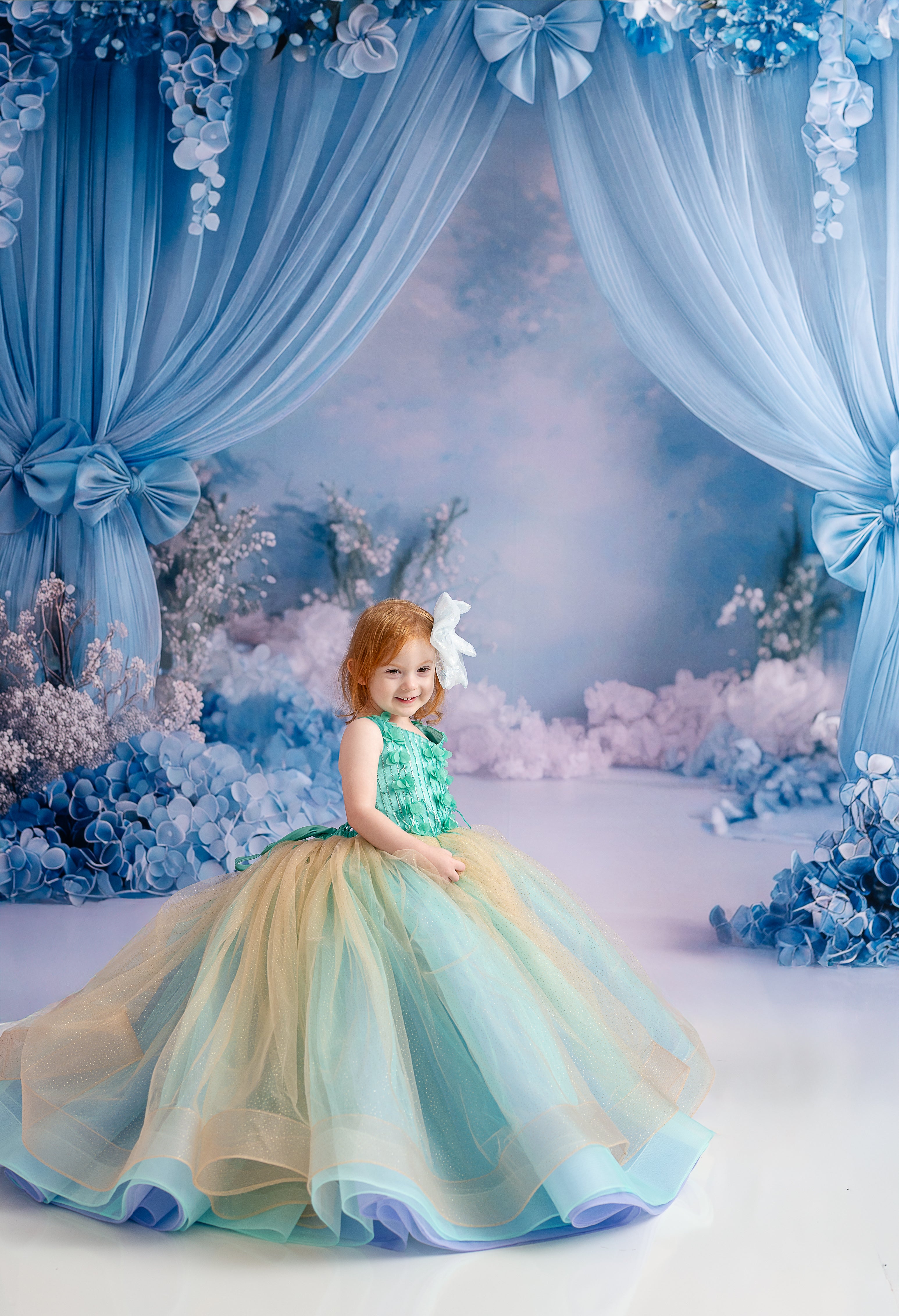 Detail shot of the shimmering gold accents woven into the aqua layers of the dress.