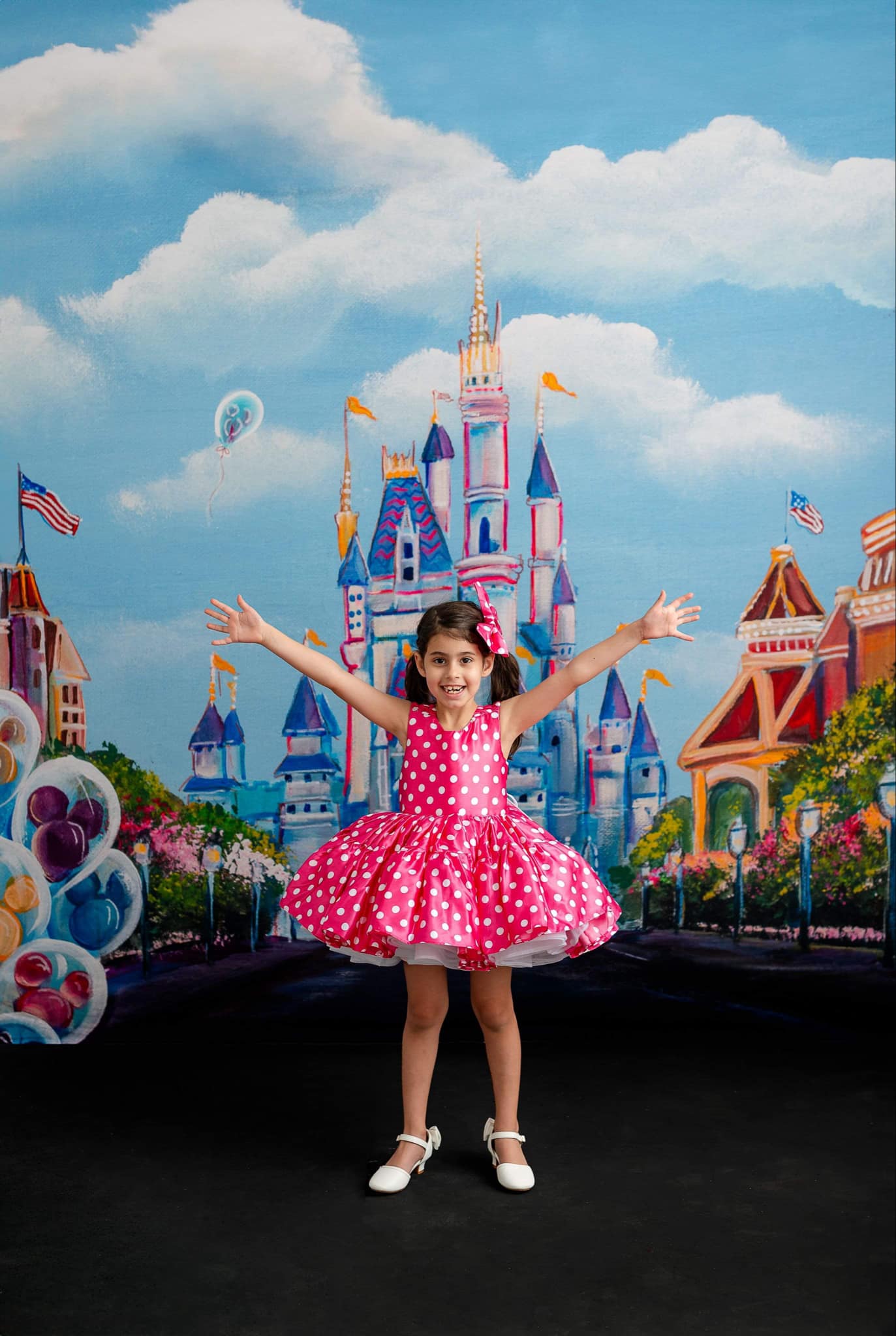 "Cute pink dress adorned with white polka dots, reminiscent of Minnie Mouse, with a classic bow detail and playful puff sleeves."