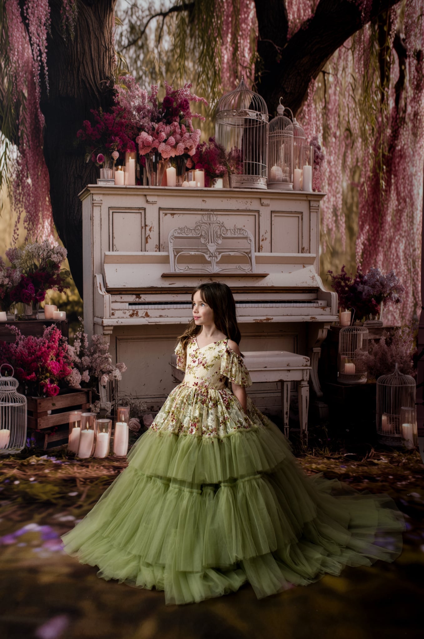 Custom child gown on mannequin with floral off-shoulder bodice and full sage tulle skirt against marble backdrop.