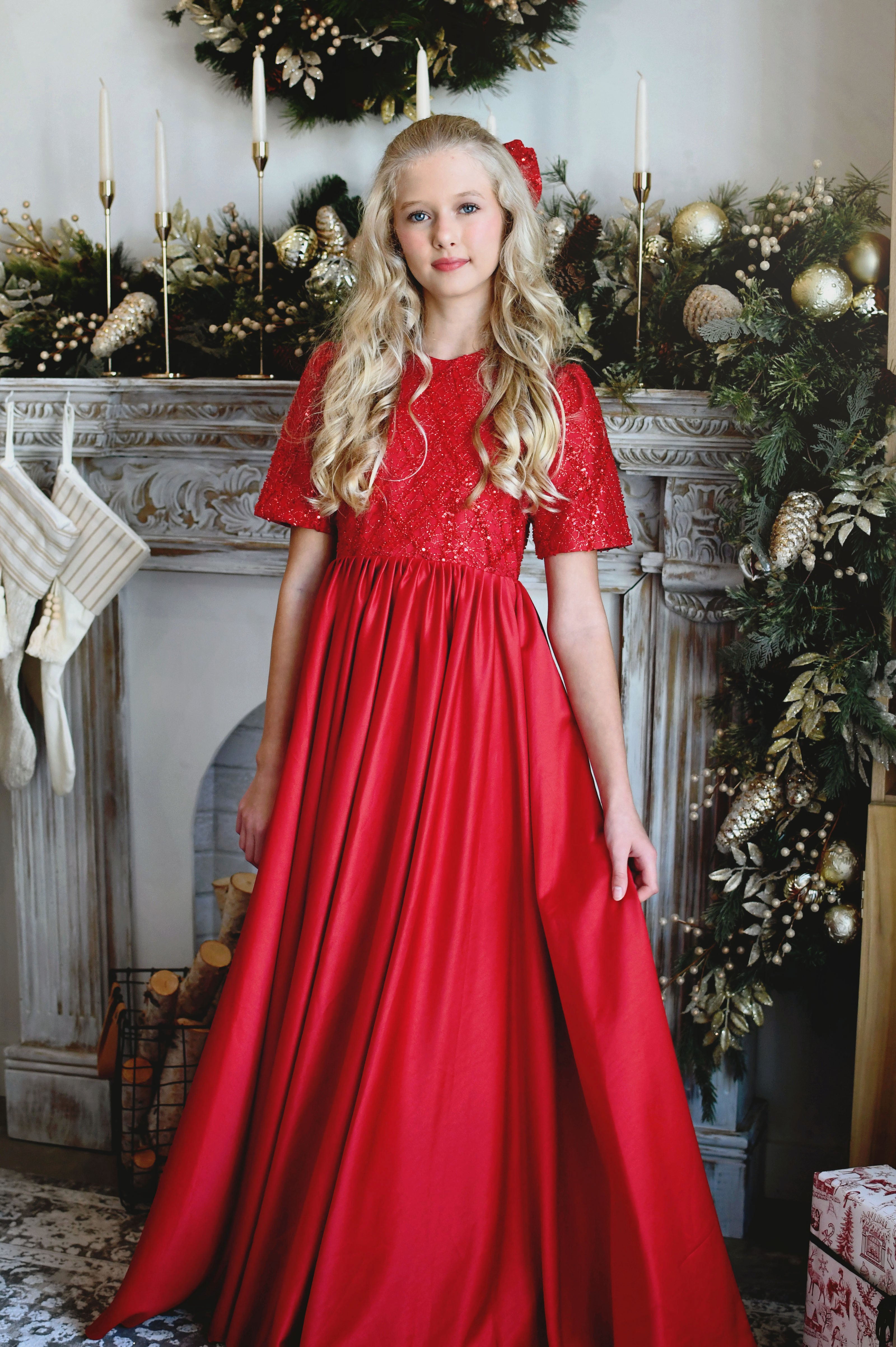 Girl wearing a red satin Holiday gown