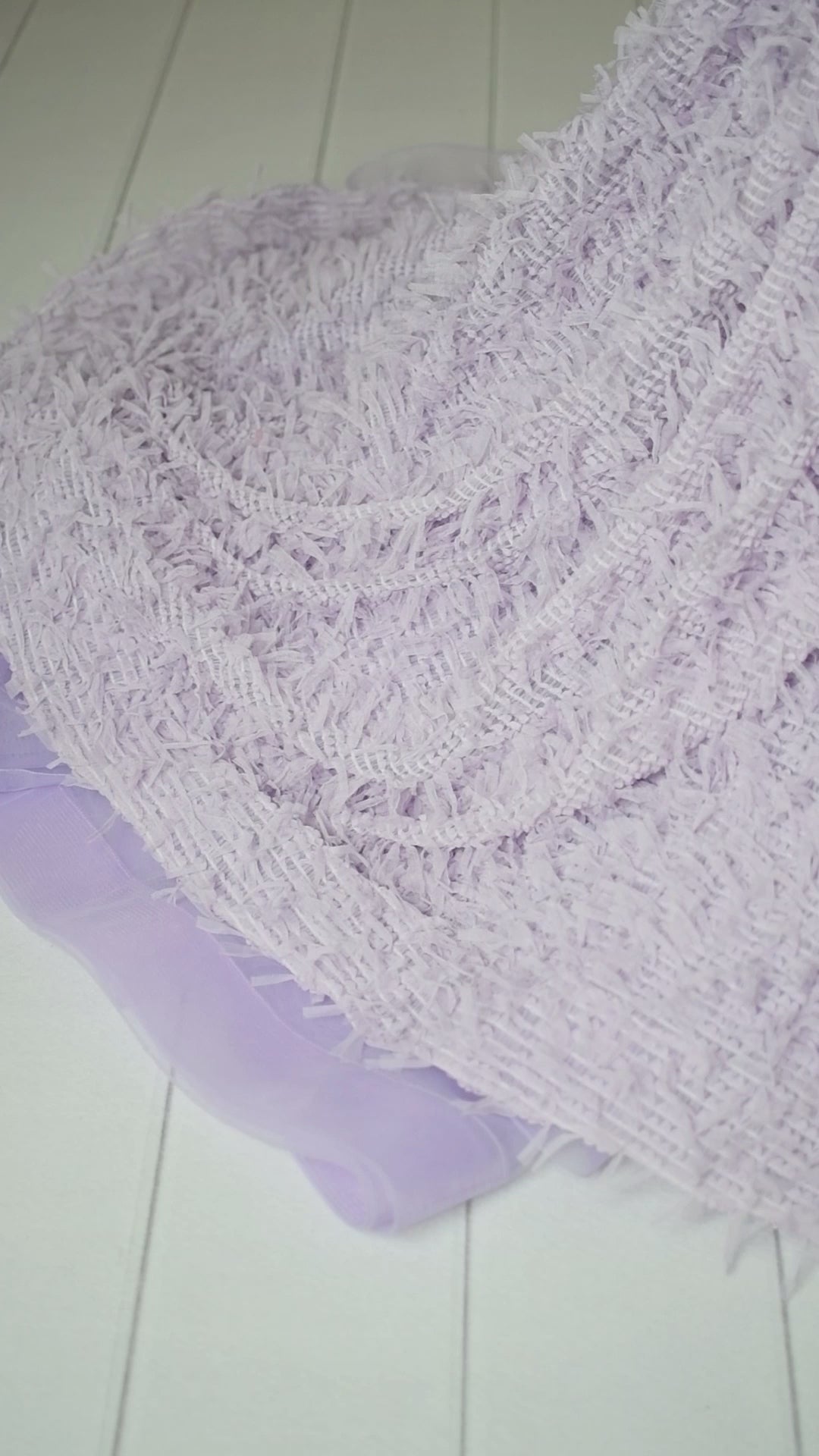 Soft lavender couture gown with corseted back and flowing train effect.