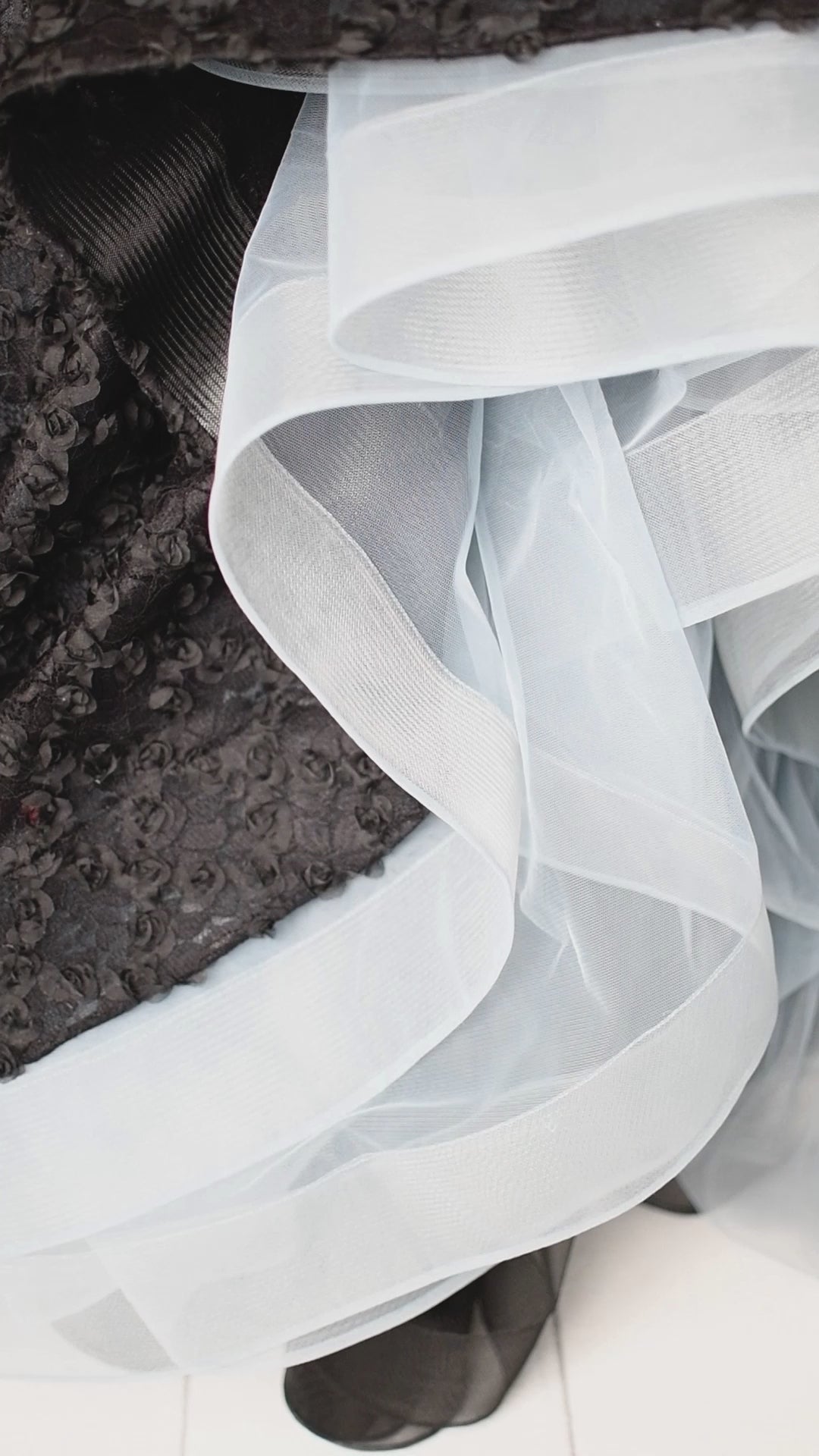 Golden butterfly bodice contrasted by a full, black rosette-textured skirt for a fairytale look.