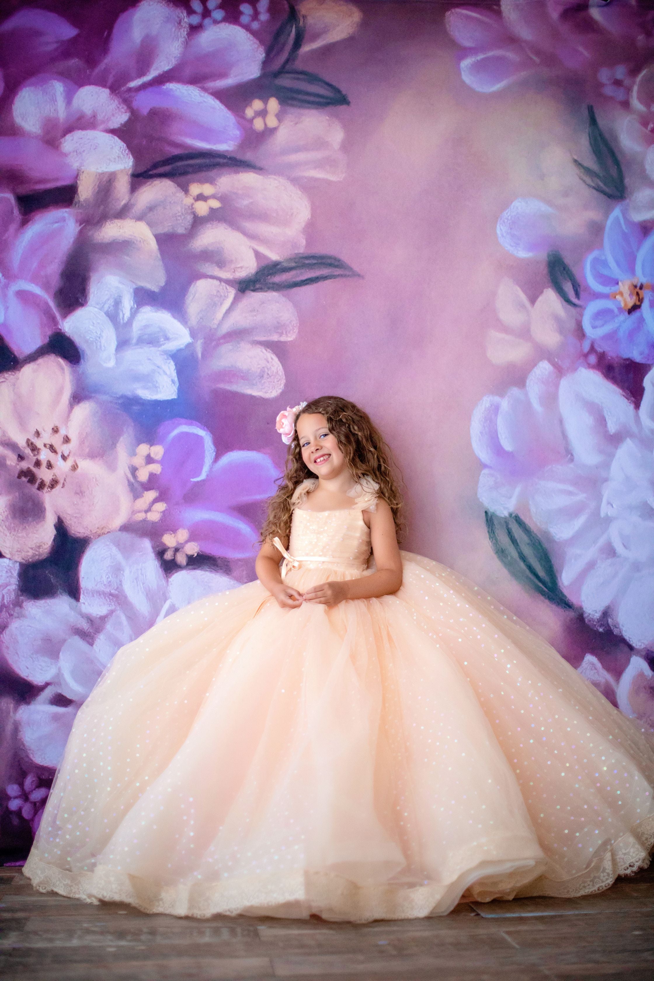 Little girl dressed in a whimsical confetti floor length dress