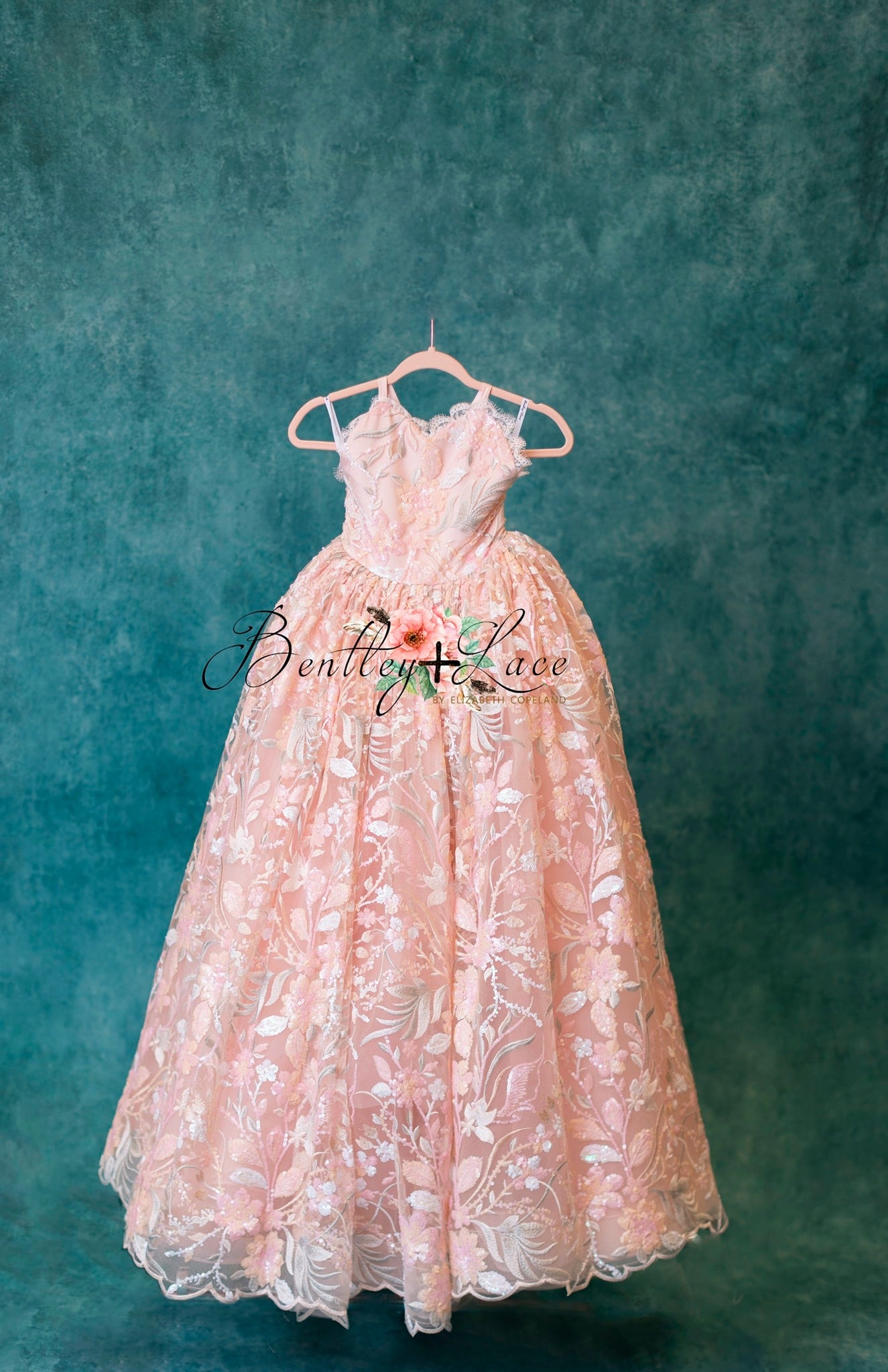 "Back view of the Marley gown featuring an elastic back and shoulder ties for easy size adjustment."