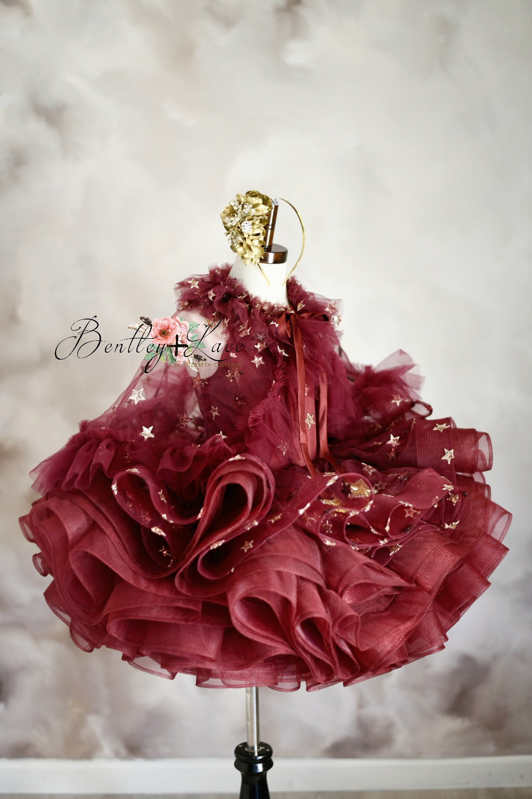 Styled shoot featuring the dress and cape in a holiday-themed setting.