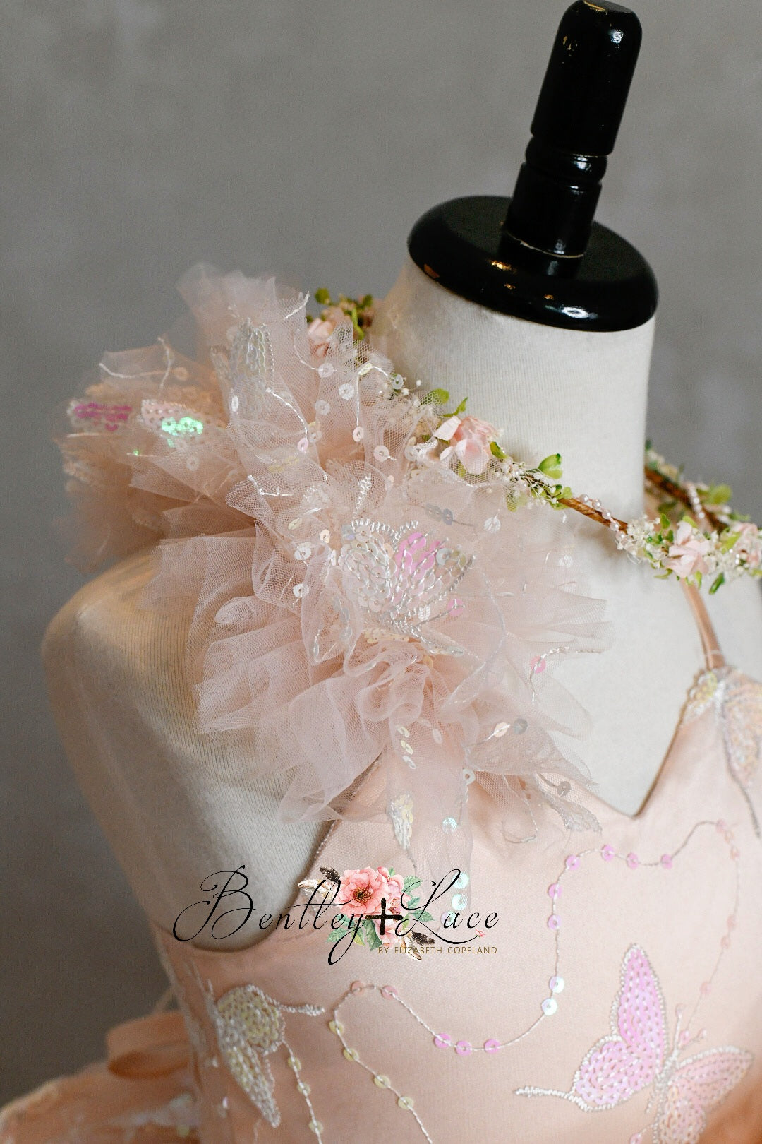 "Anastasia gown styled in an outdoor setting, capturing the beauty of its shimmering sequins against natural light."