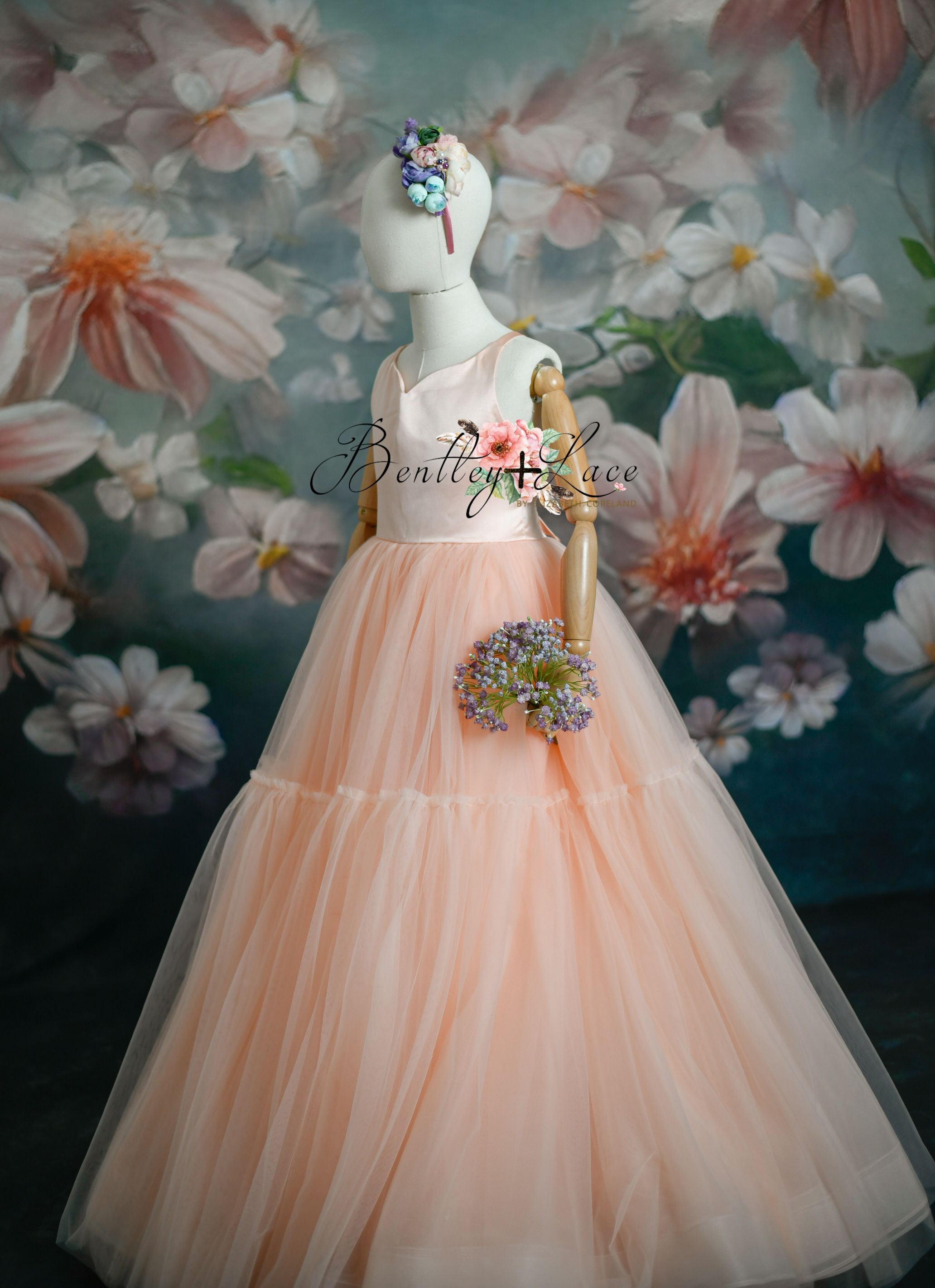 "Floor-sweeping peach gown with soft ruffles and delicate bodice detailing"