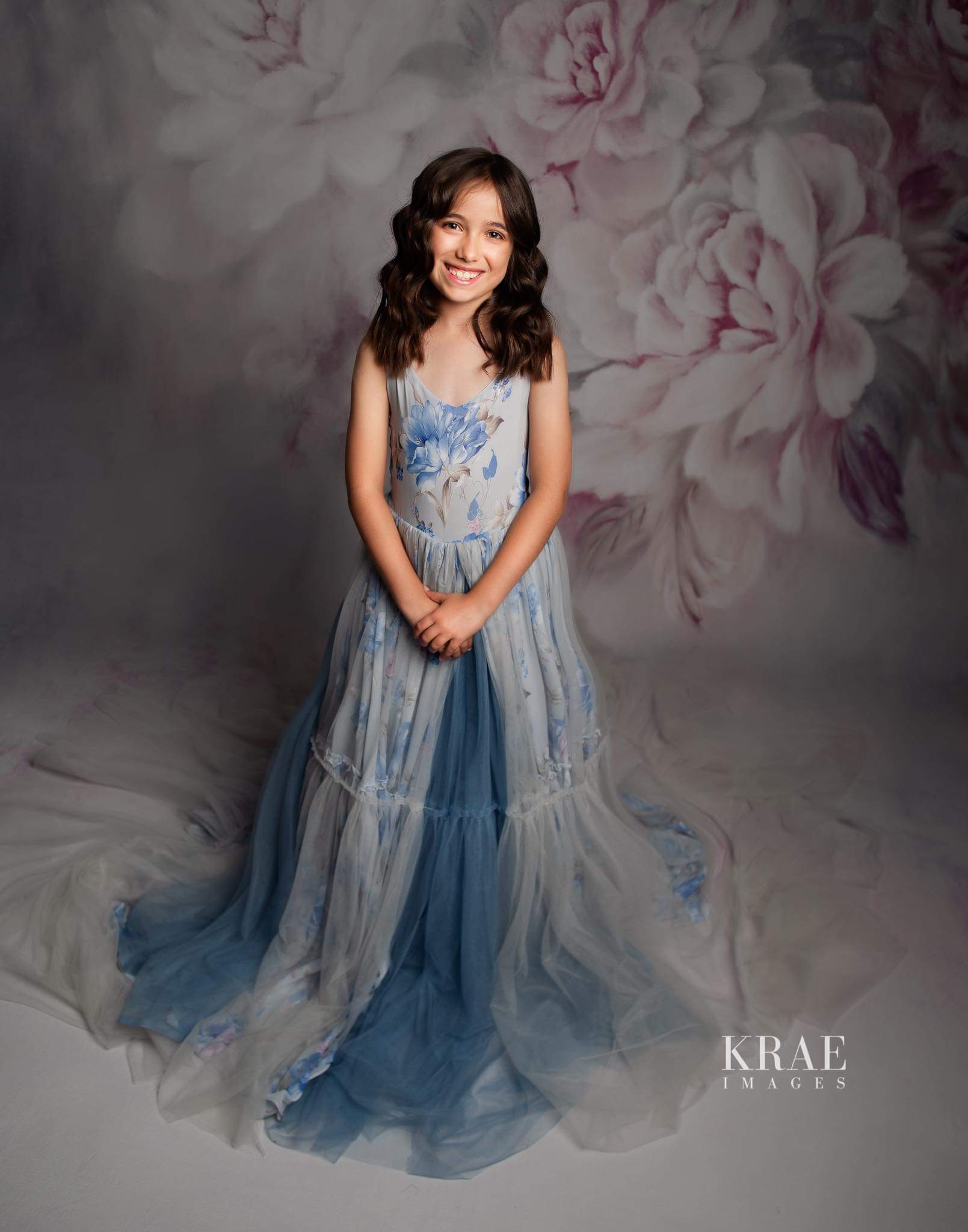 Girl twirling in Hillary gown with dramatic trailing skirt.