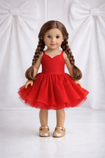 Doll wearing a red dress with a white background