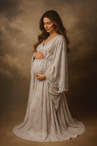 Pregnant woman in a floral dress against a warm-toned background