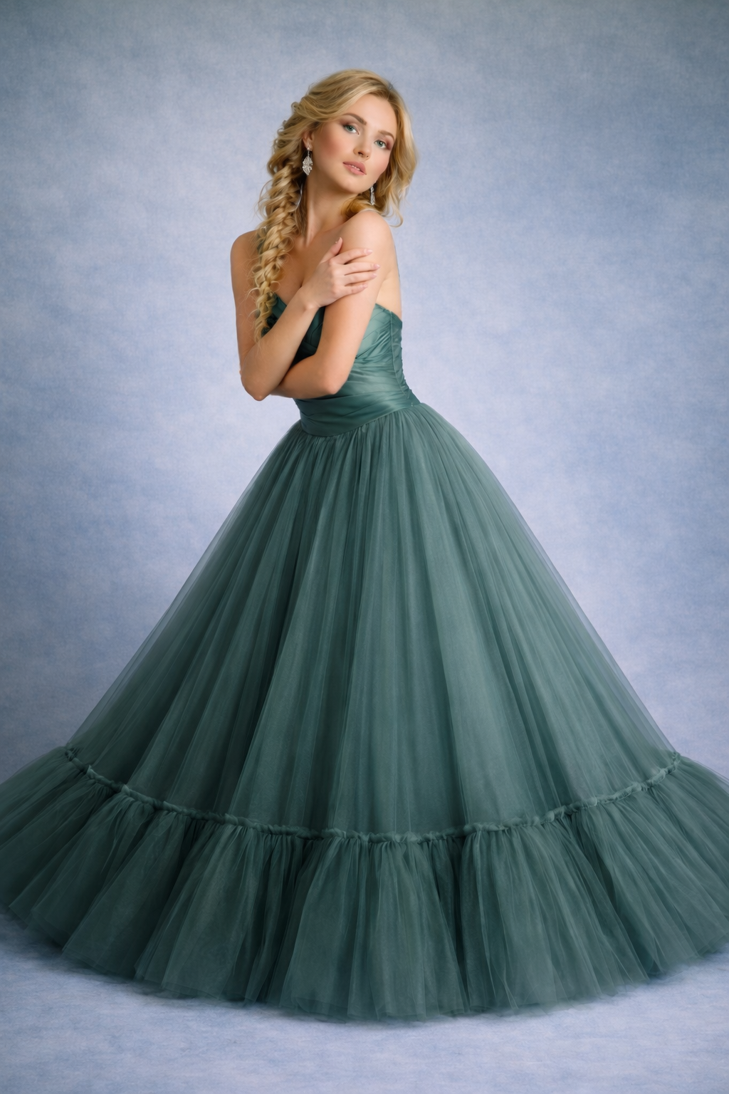 Woman in a green gown against a gray background