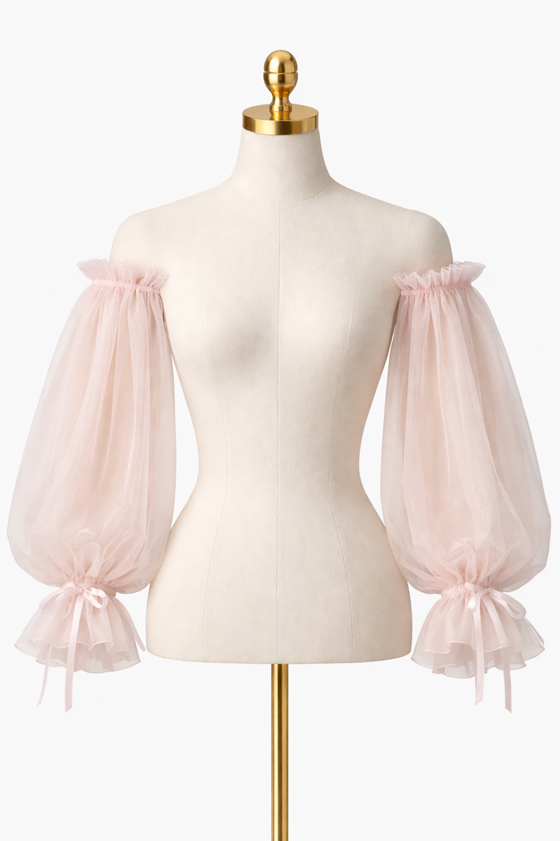 Mannequin wearing a light pink blouse with sheer sleeves on a white background