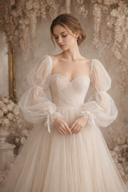 Woman wearing a elegant white wedding dress with sheer sleeves in a floral setting
