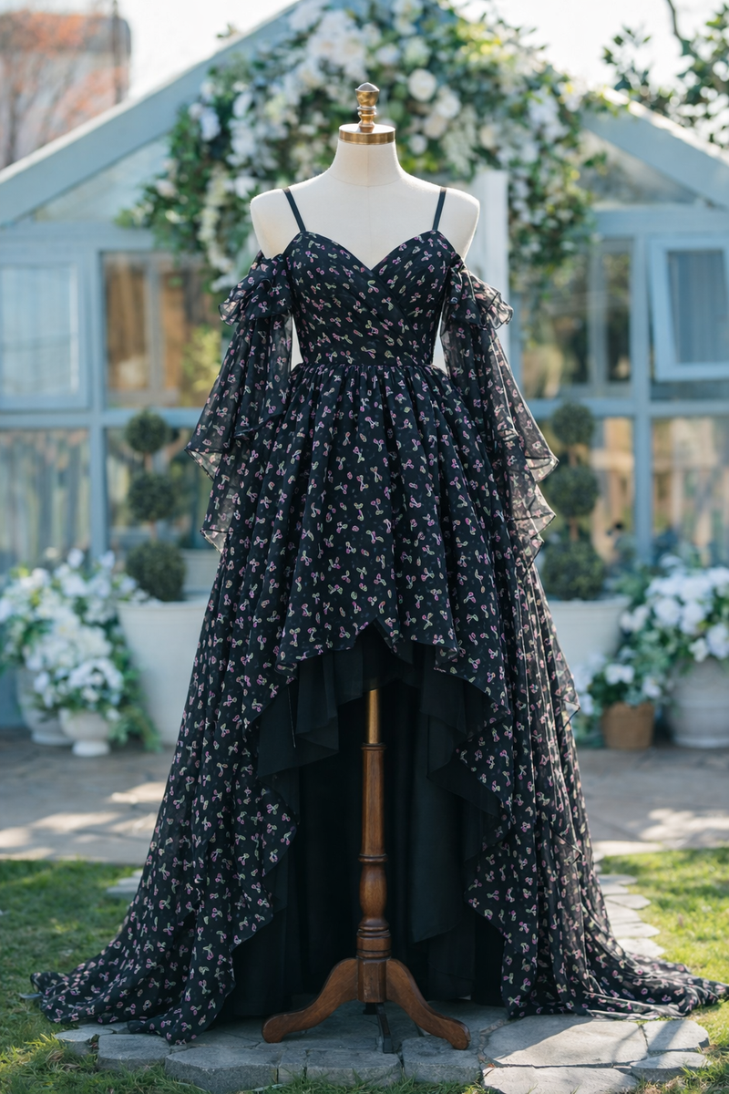 Black floral dress on a mannequin in an outdoor setting with flowers and a building in the background