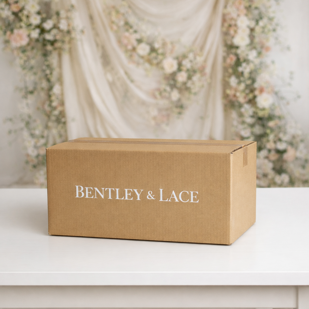 Brown box with 'Bentley & Lace' branding on a white surface with floral decorations in the background