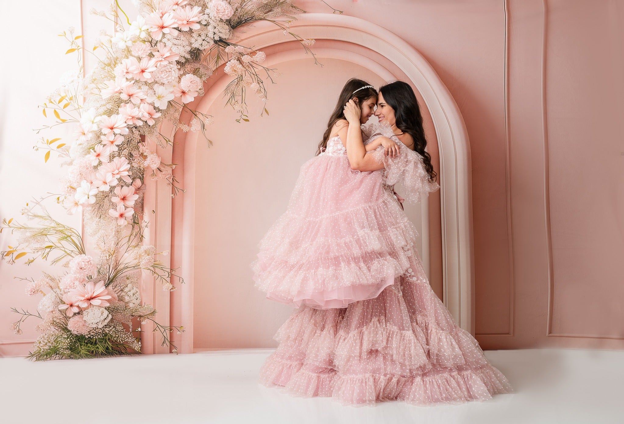 "Matching gowns for moms and daughters, blending sophistication and playfulness."
