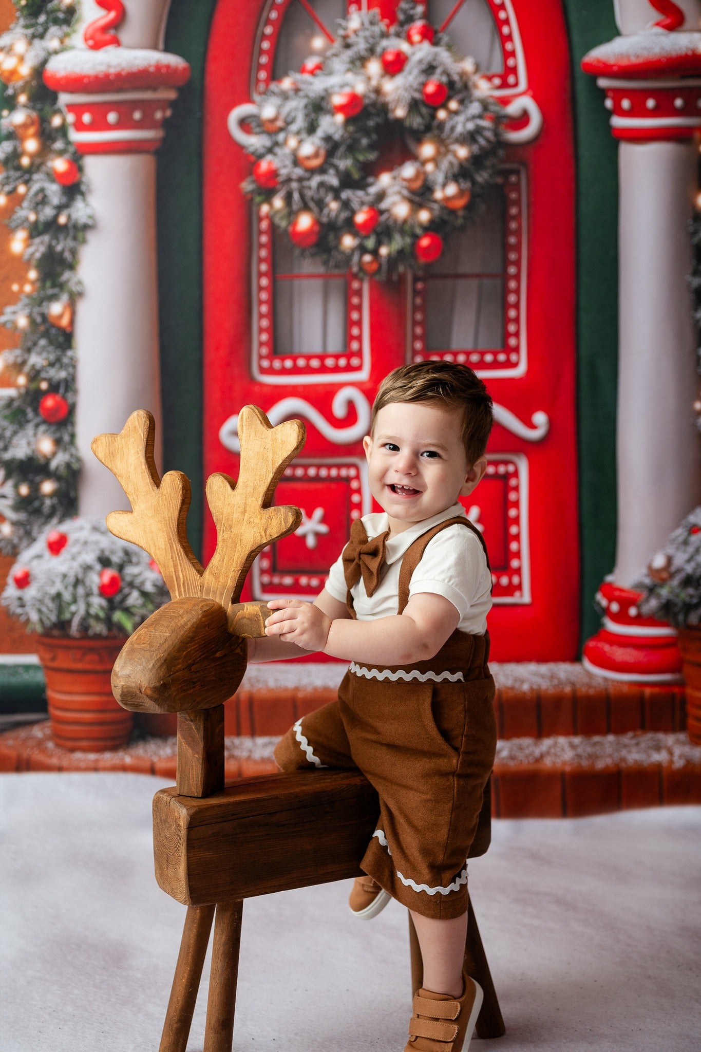 boy wearing a gingerbread inspired suspender short set