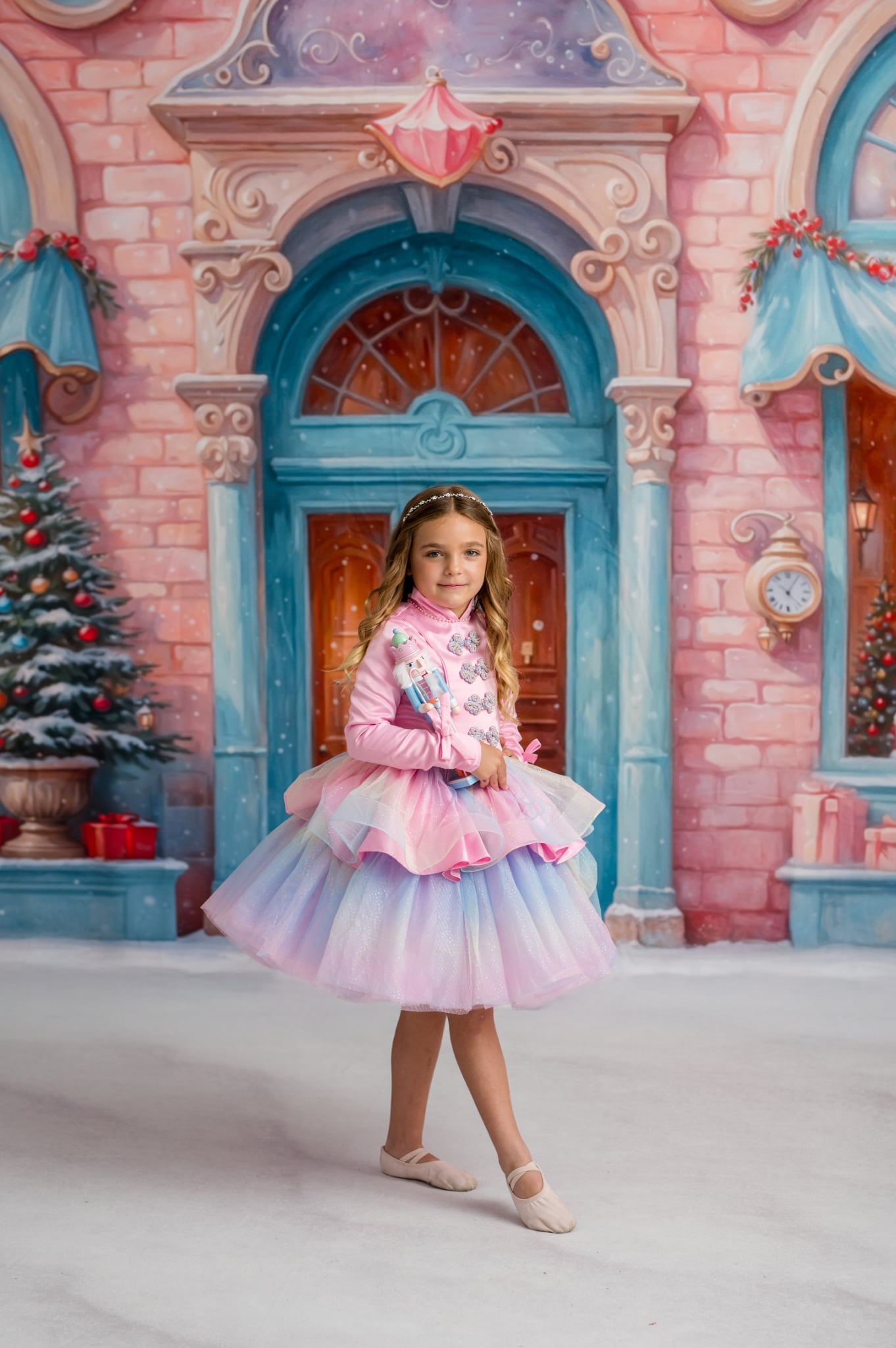 Girl in pastel Candy Carousel dress posing in Christmas Candyland backdrop.

